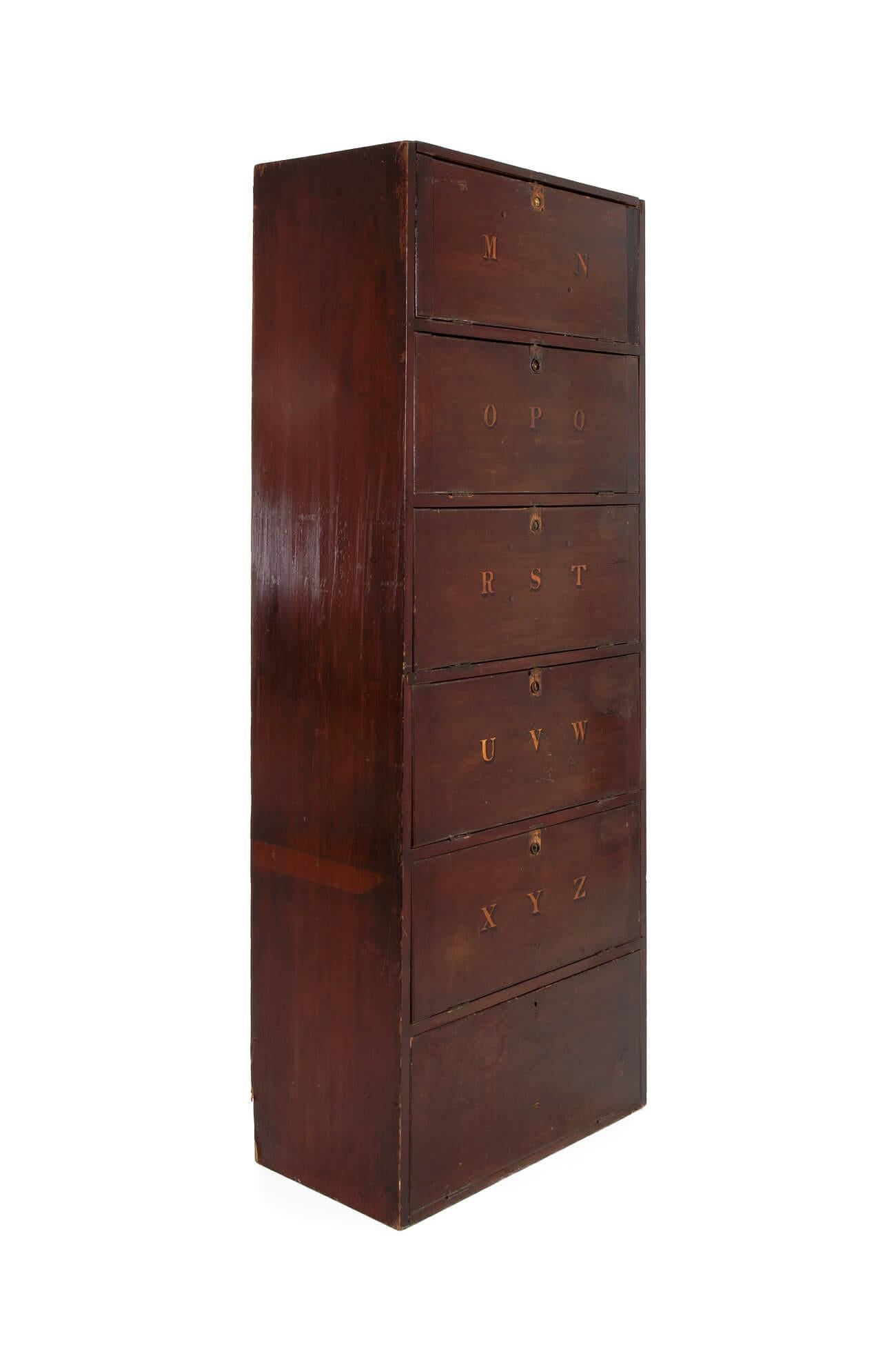 A wonderful legal clerks filing cabinet or deed box in painted pine. In original condition with six hinged shelves and hand-painted alphabetical doors. 
English, circa 1900.

Additional information:
H 182.50 cm (H 71.8 inches)
W 68.5 cm (W 26.9