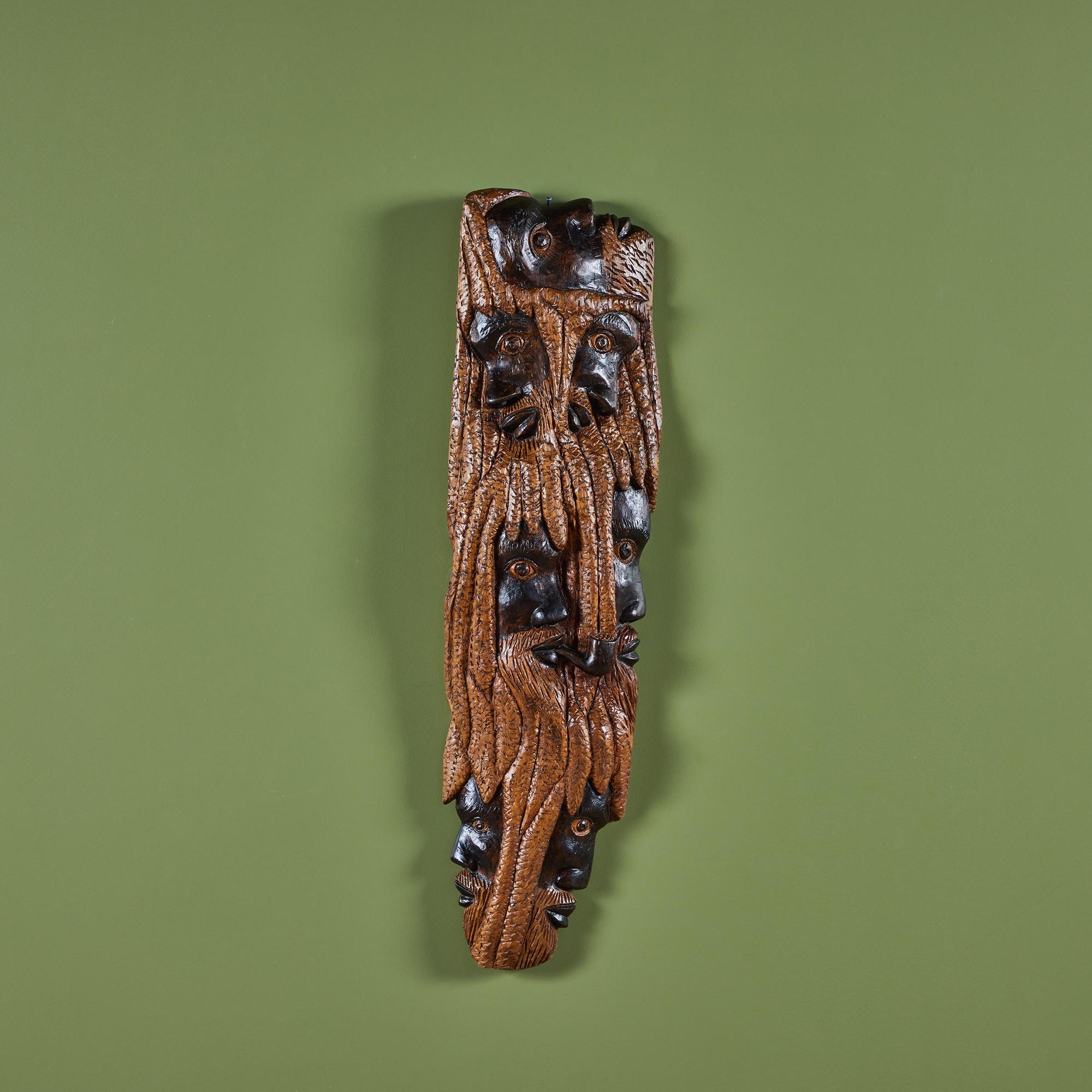 Alphaious Campbell carved wood wall hanging, c.1987. The painted folk art piece showcases various profiles of a bearded man.

Dimensions 
9