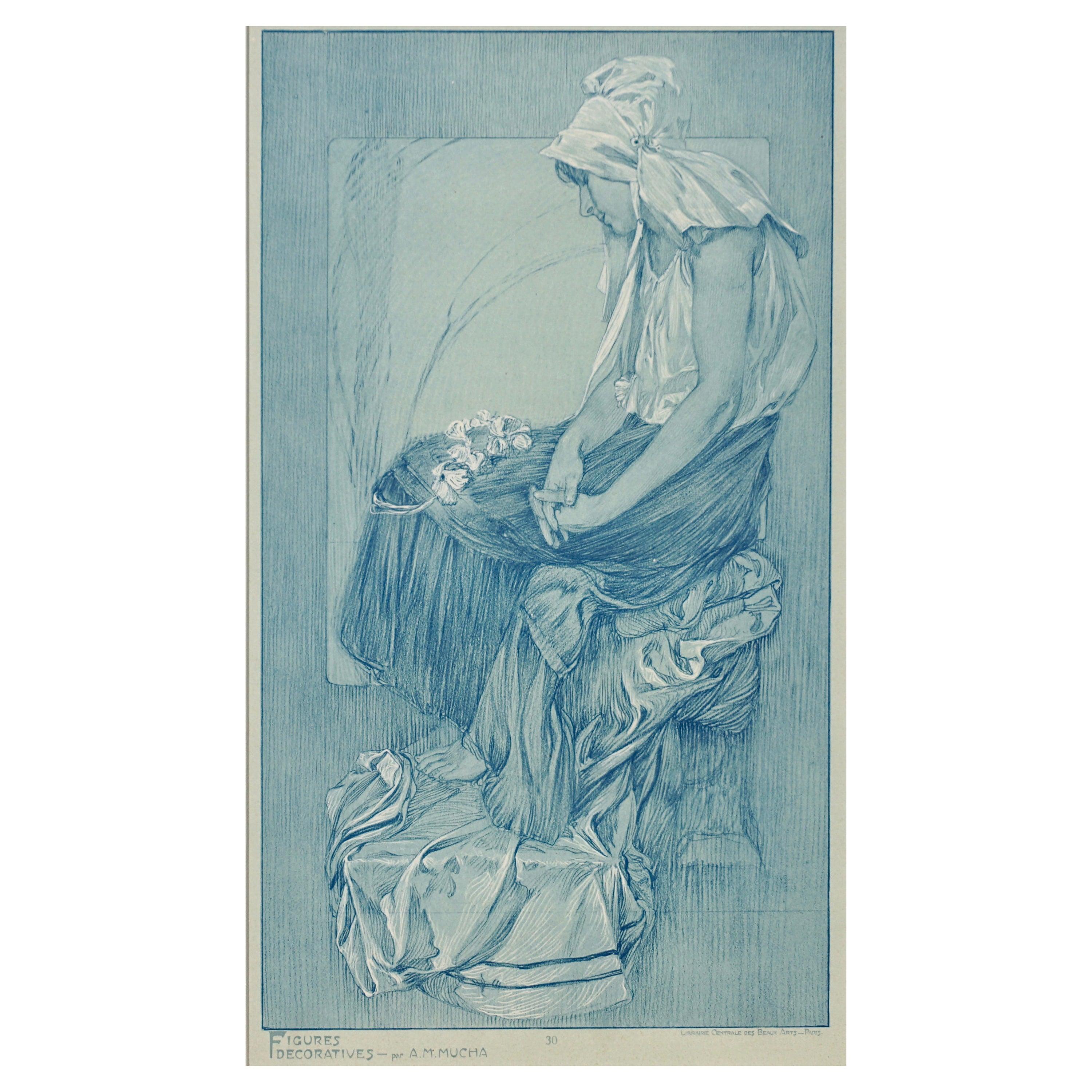 A framed Art Nouveau lithograph collotype poster by Alphone Mucha from 1905 representing the artist’s sketches of nudes, women and beautiful ladies in blues and white pigments on vellum paper. Plate 30 of “Figures Decoratives par A. M. Mucha,”