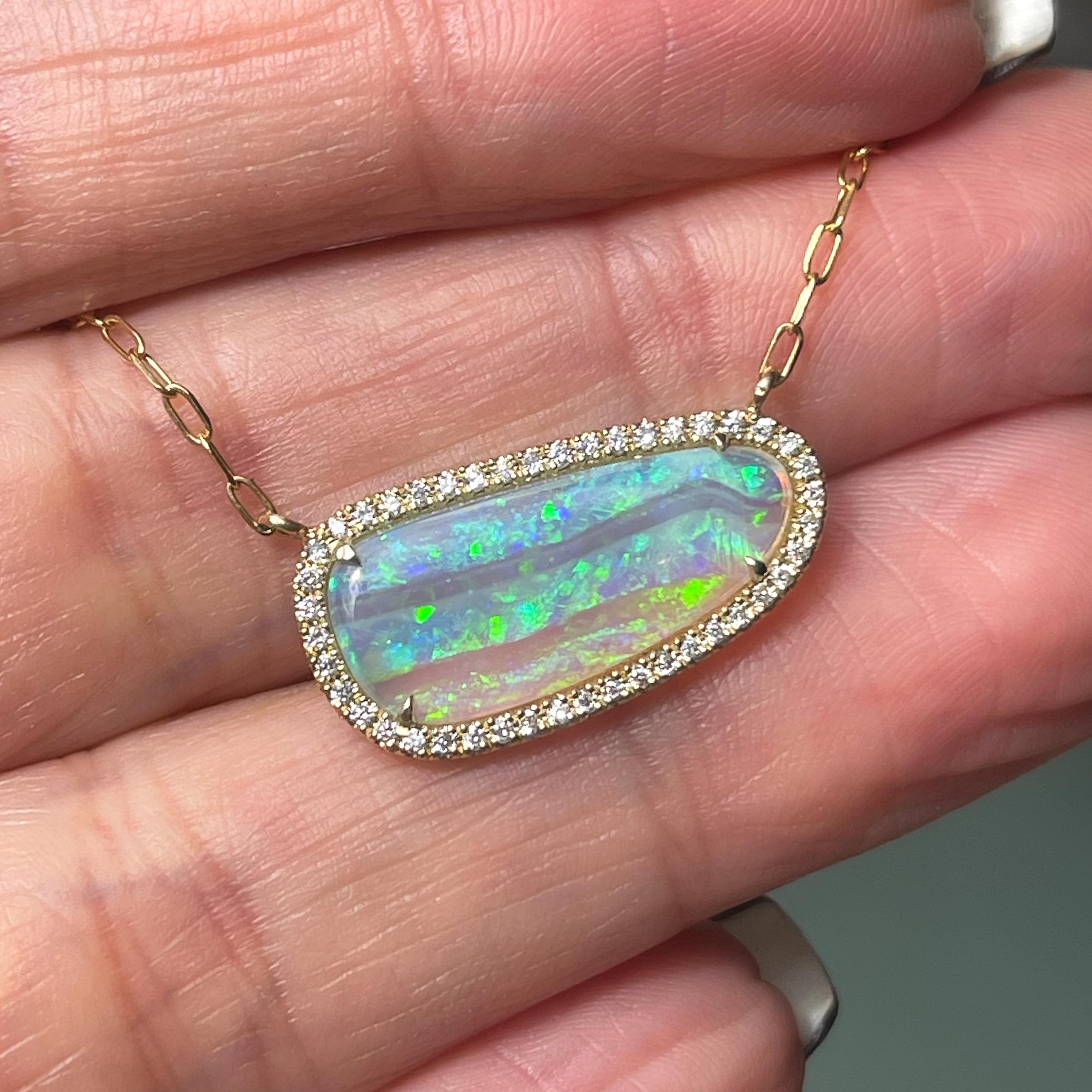 Fresh tracks carve through the facade of this Australian Opal Necklace. The Crystal Opal glistens like fresh powder in the sun, surrounded by a halo of pave diamonds, each one glistening like a tiny snowflake. The gold opal necklace tells a story of