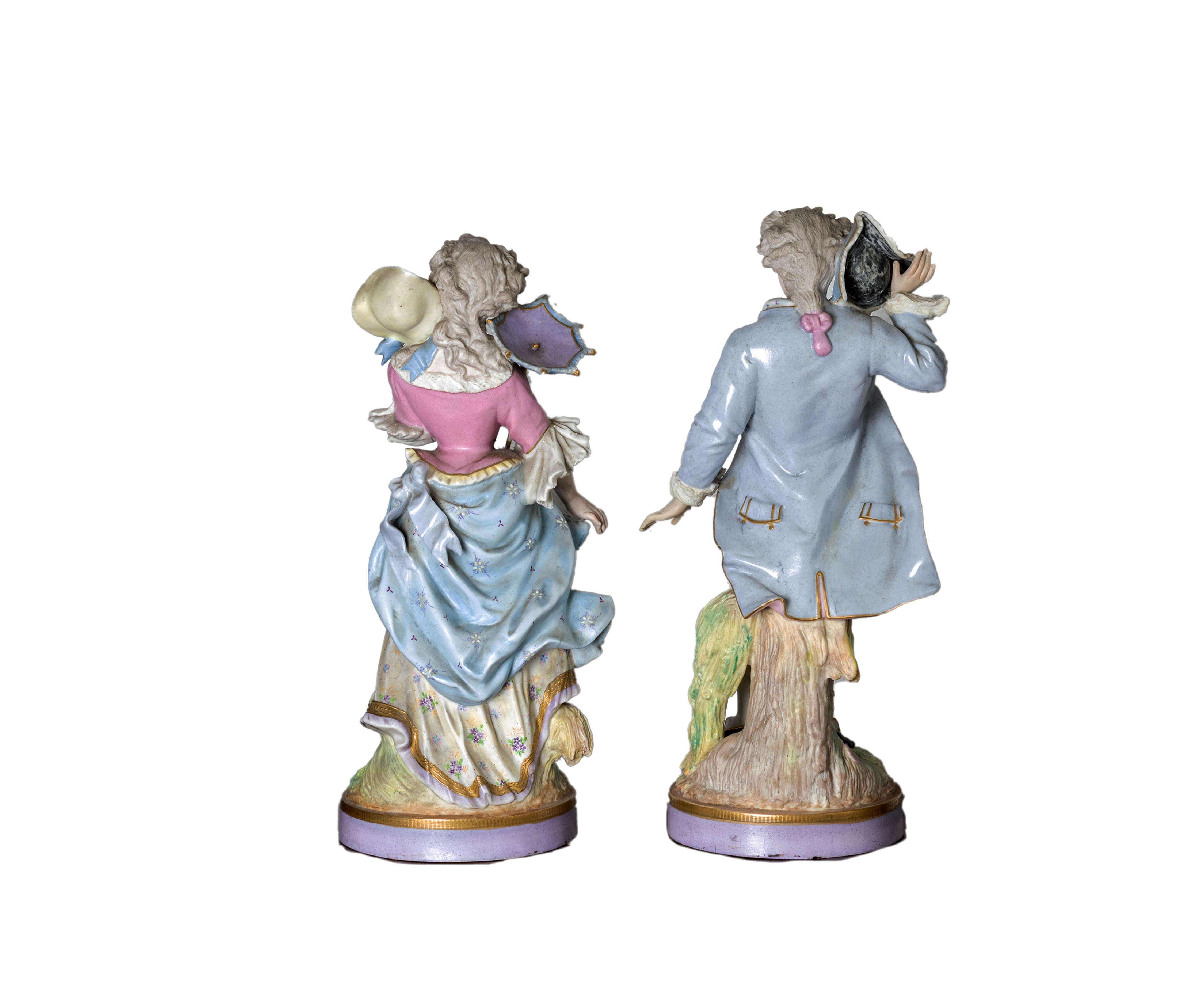 A noble baroque style porcelain figurine couple designed by Alpinien Margaine (French, active after 1854) by the foundry Gibus et Cie (1853–1972) in Limoges, France in a baby blue motif, signed «4 M), both piueces titled «Elégante à l'ombrelle^» and