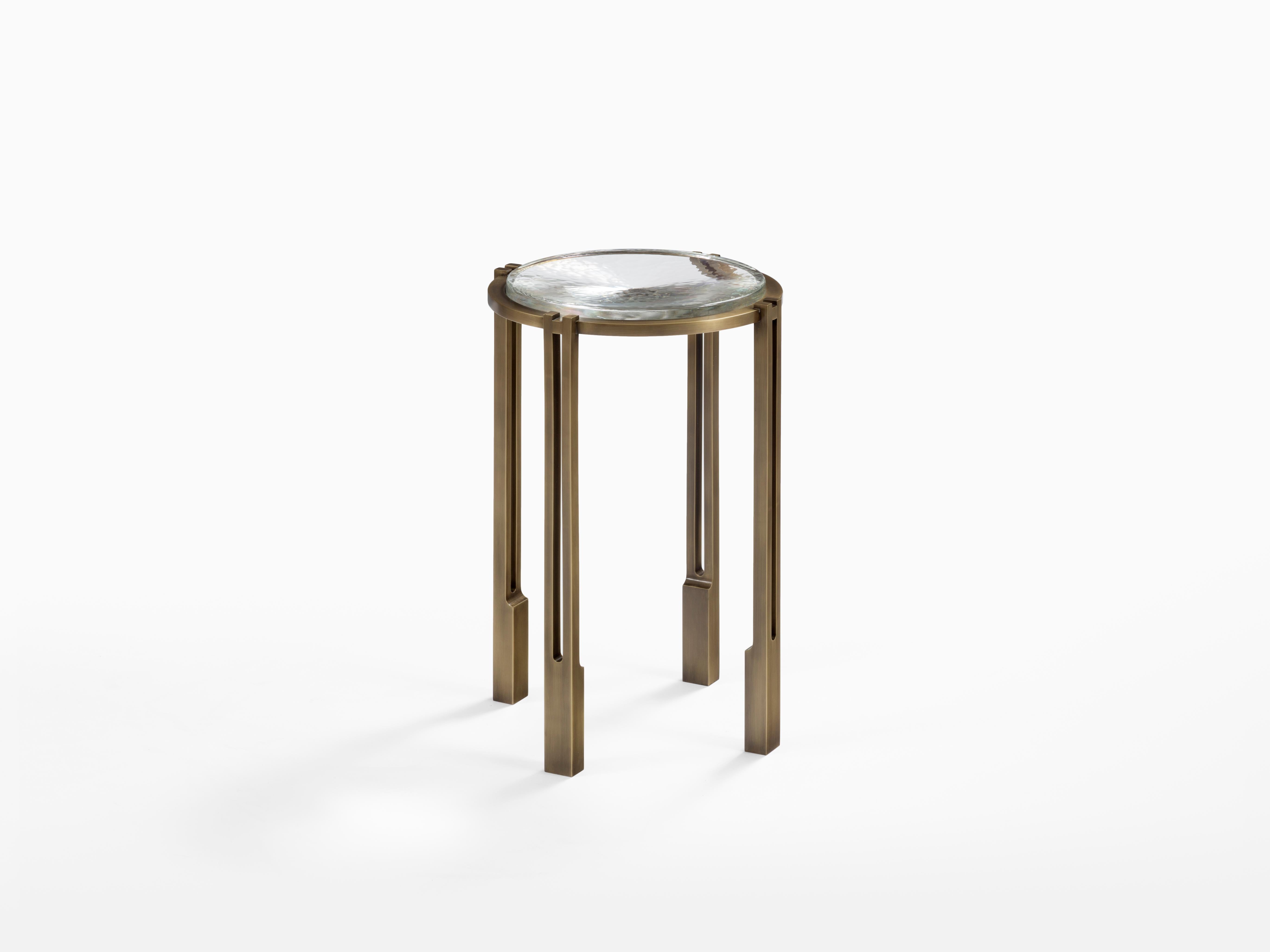 Metal and cast glass strike the perfect balance in the alter occasional table by Chai Ming Studios. Produced by our craftspeople to exacting standards, the architectural metal frame is expertly detailed and highlights the unique characteristics of