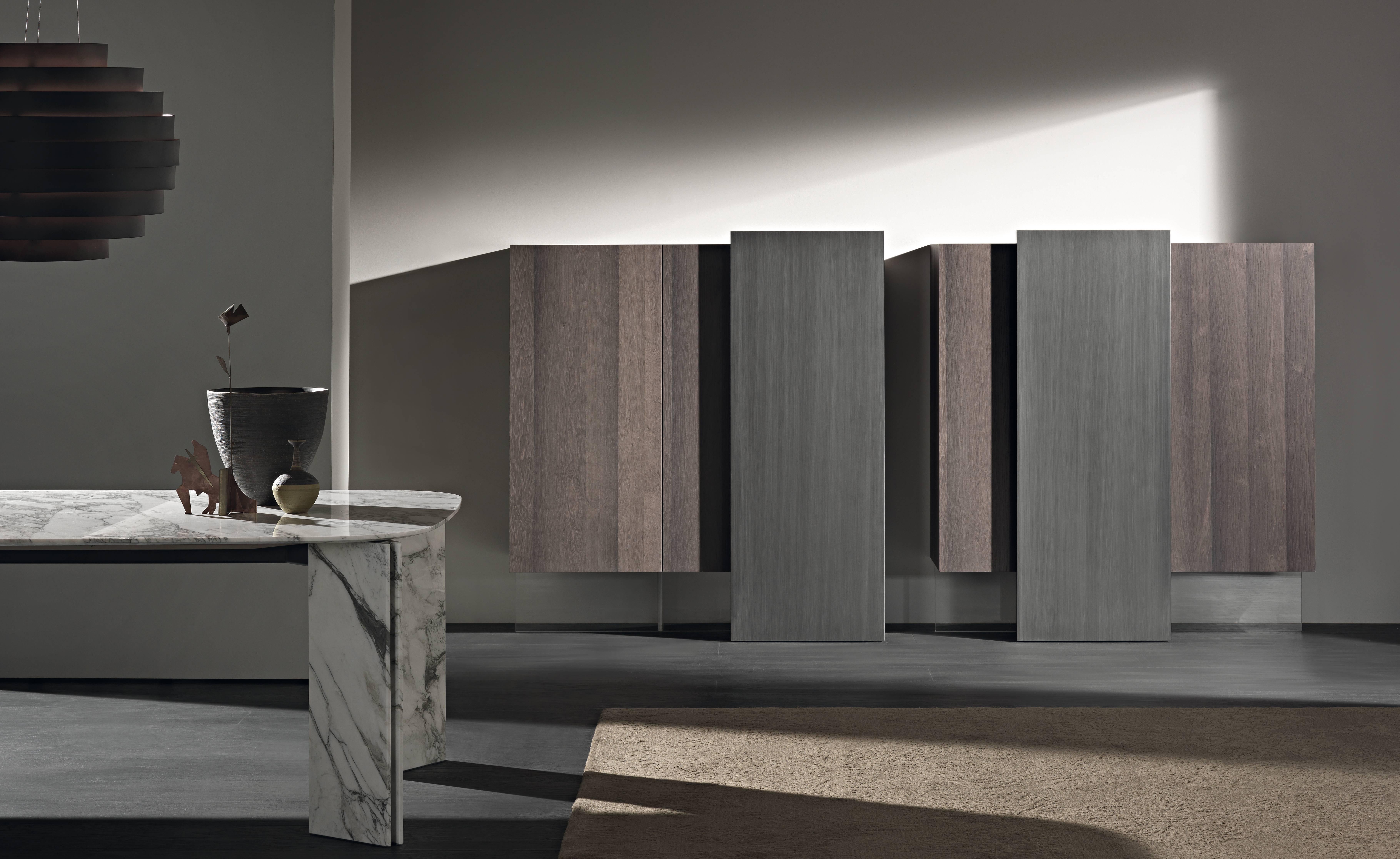 Identities strengthened by asymmetry: harmonious together, but with independent potential. The two vertical Alterego sideboards are conceived from a craft vision that creates an association between the woods and the hand brushed metal effect finish.