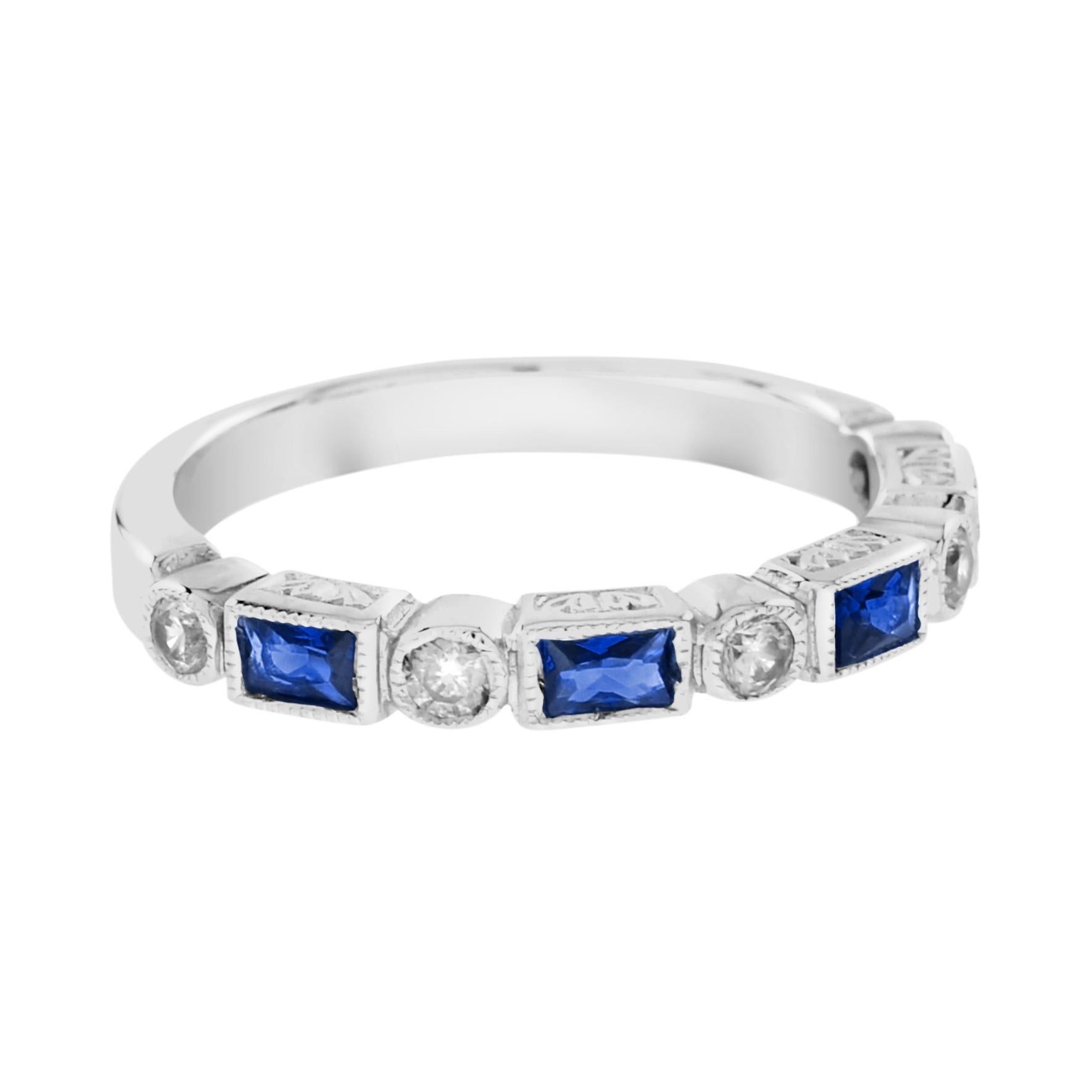 Inspired by the Art Deco period, this ring features alternate round brilliant cut diamonds and baguette blue sapphire, elegantly framed by a millgrain edge. This white gold band is the perfect alternative half eternity ring. The ring is available as