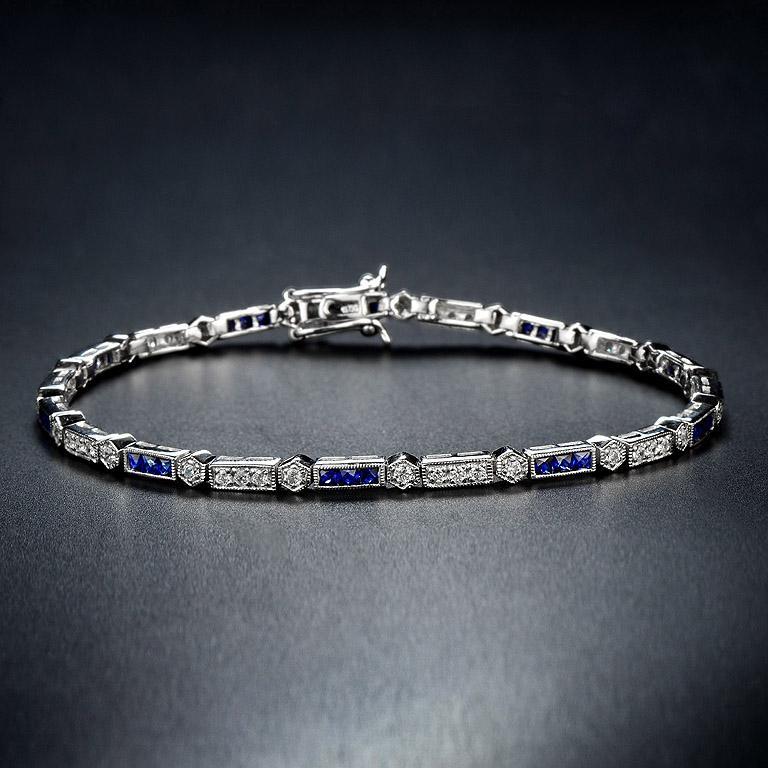 Luxuriant and colorful, this Aimée bracelet features alternating triple French cut sapphire and round brilliant-cut diamonds. lends security to the classic Art-Deco style and a box clasp with hidden safety keeps this stunner secure. 14K White Gold.