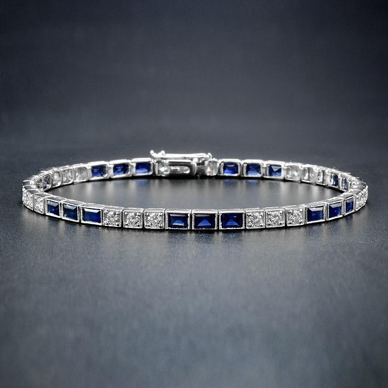 A gorgeous gemstone line bracelet from the Art Deco era!, this fabulous piece features an alternating pattern comprised of sections of sapphires and diamonds. The bracelet fastens at a push clasp seamlessly hidden within the final link, and a hinged