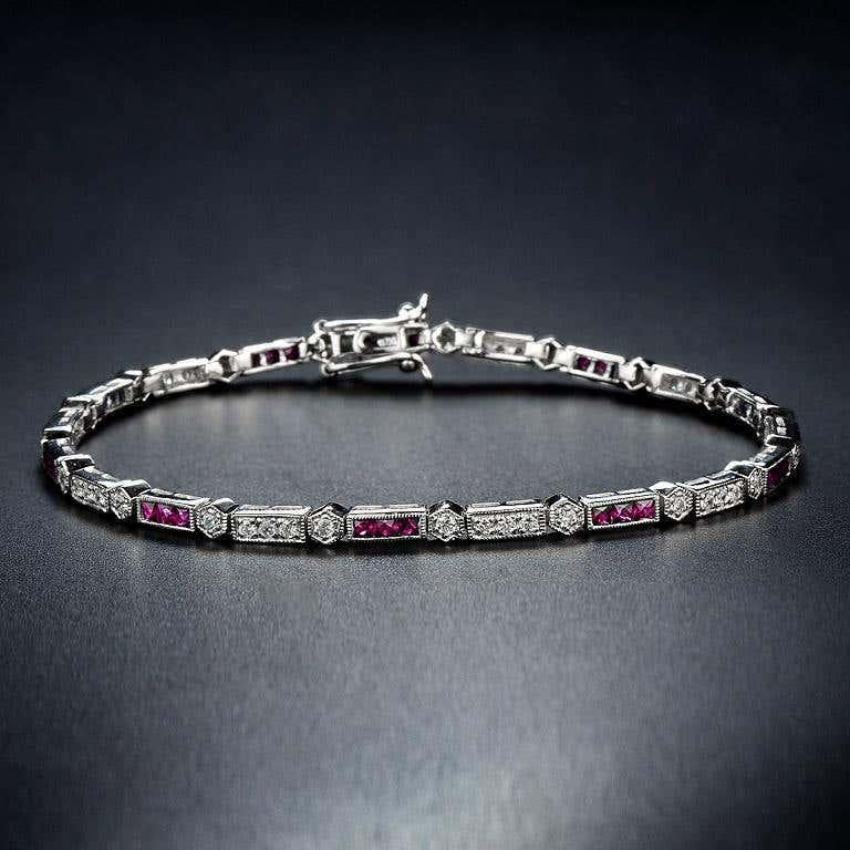 Luxuriant and colorful, this Aimée bracelet features alternating triple French cut ruby and round brilliant-cut diamonds. lends security to the classic Art-Deco style and a box clasp with hidden safety keeps this stunner secure. 14K White Gold.