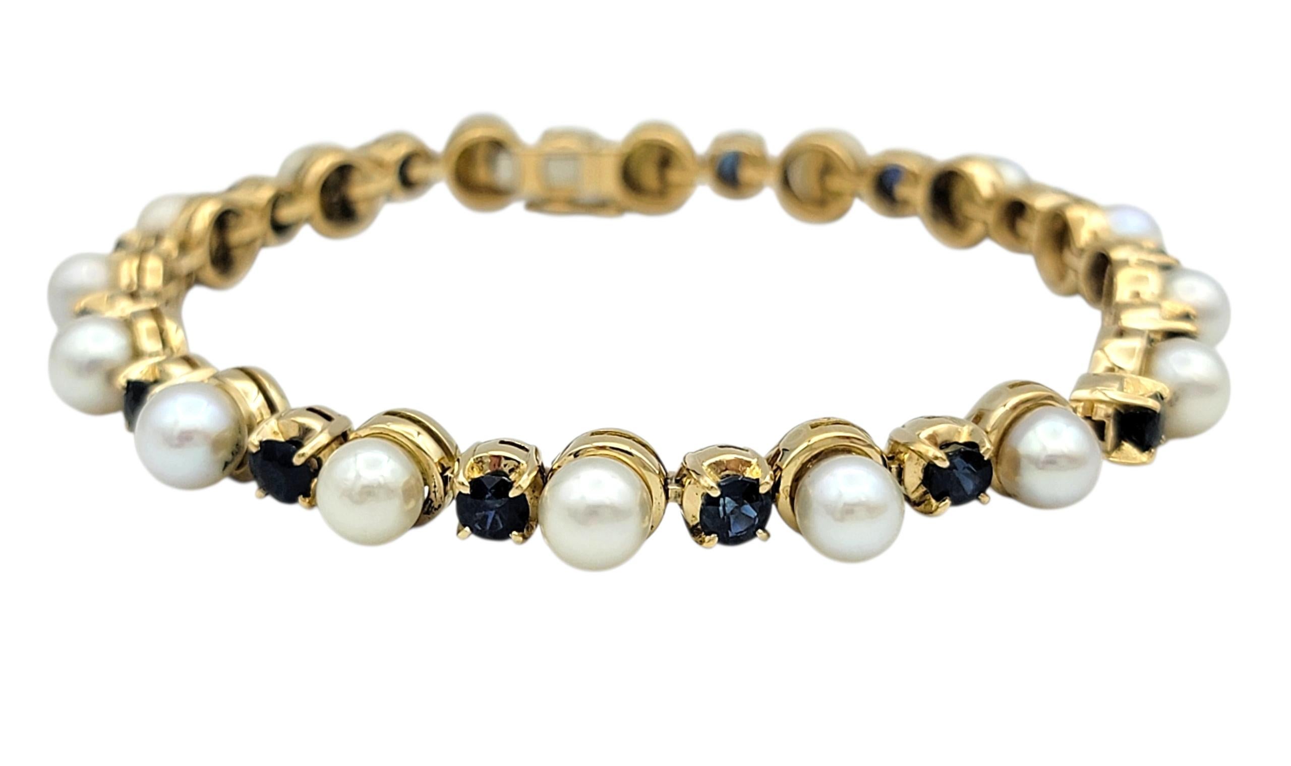 Cet élégant bracelet associe le luxe classique à des couleurs éclatantes dans un design de maillons raffiné. Alternant entre perles de culture lumineuses et saphirs d'un bleu profond, chaque pierre est bercée dans un riche or jaune 18 carats. Les