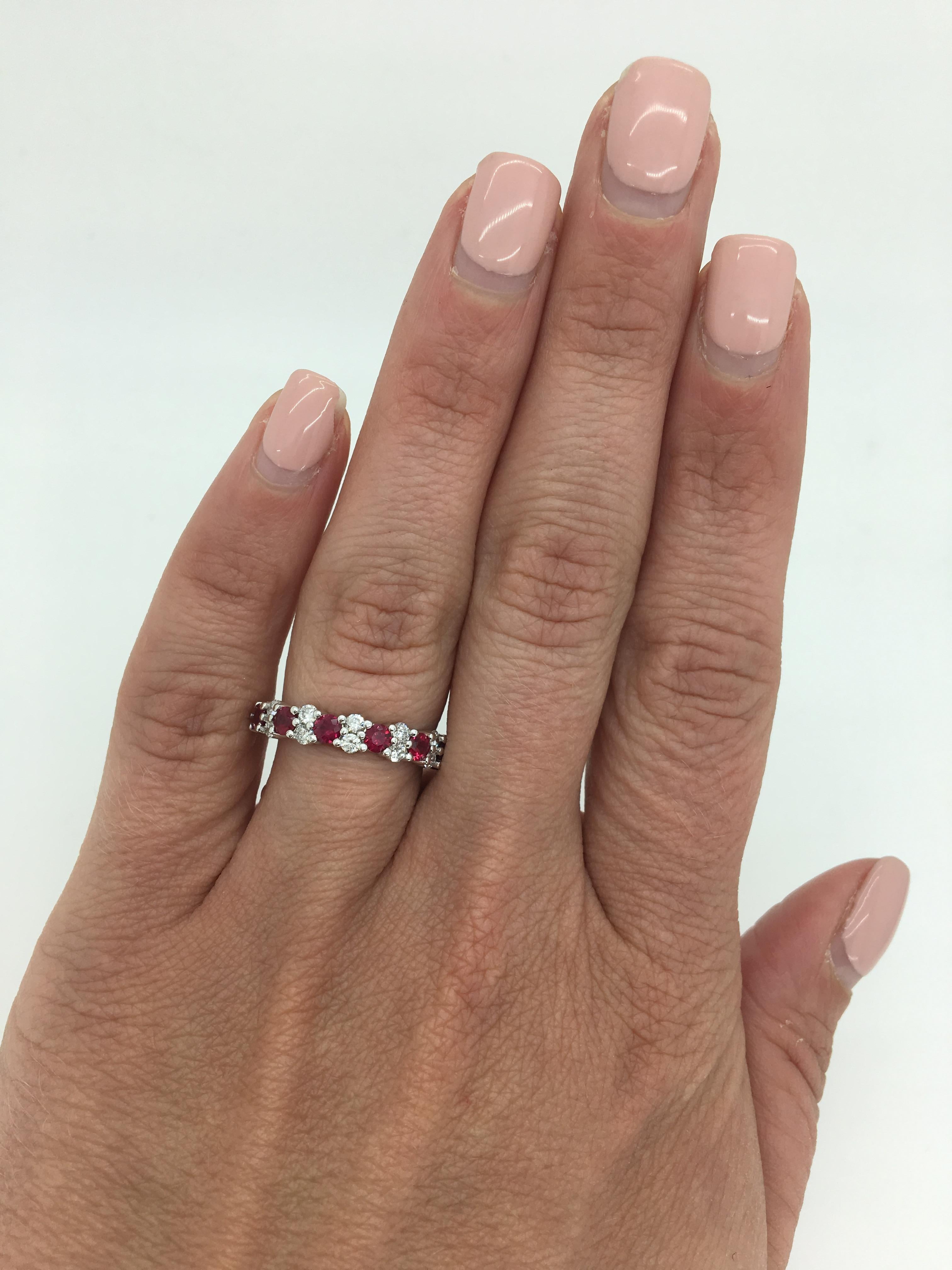 Stunning band style ring featuring Round Cut created rubies that alternate with two stunning Round Brilliant Cut Diamonds.

Gemstone: Diamond and Created Rubies
Gemstone Carat Weight: 7 Round 3mm Rubies 
Diamond Cut: 12 Round Brilliant Cut 
Average