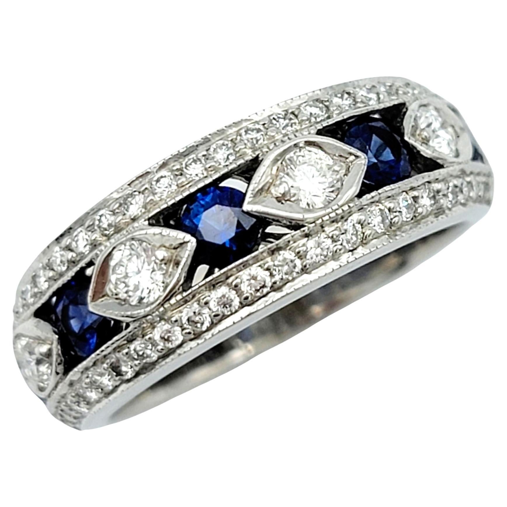 Ring size: 5 

This gorgeous 18 karat white gold band ring is a testament to refined elegance and intricate design. The focus of this captivating ring features a mesmerizing alternating pattern of brilliant blue sapphires and pristine white