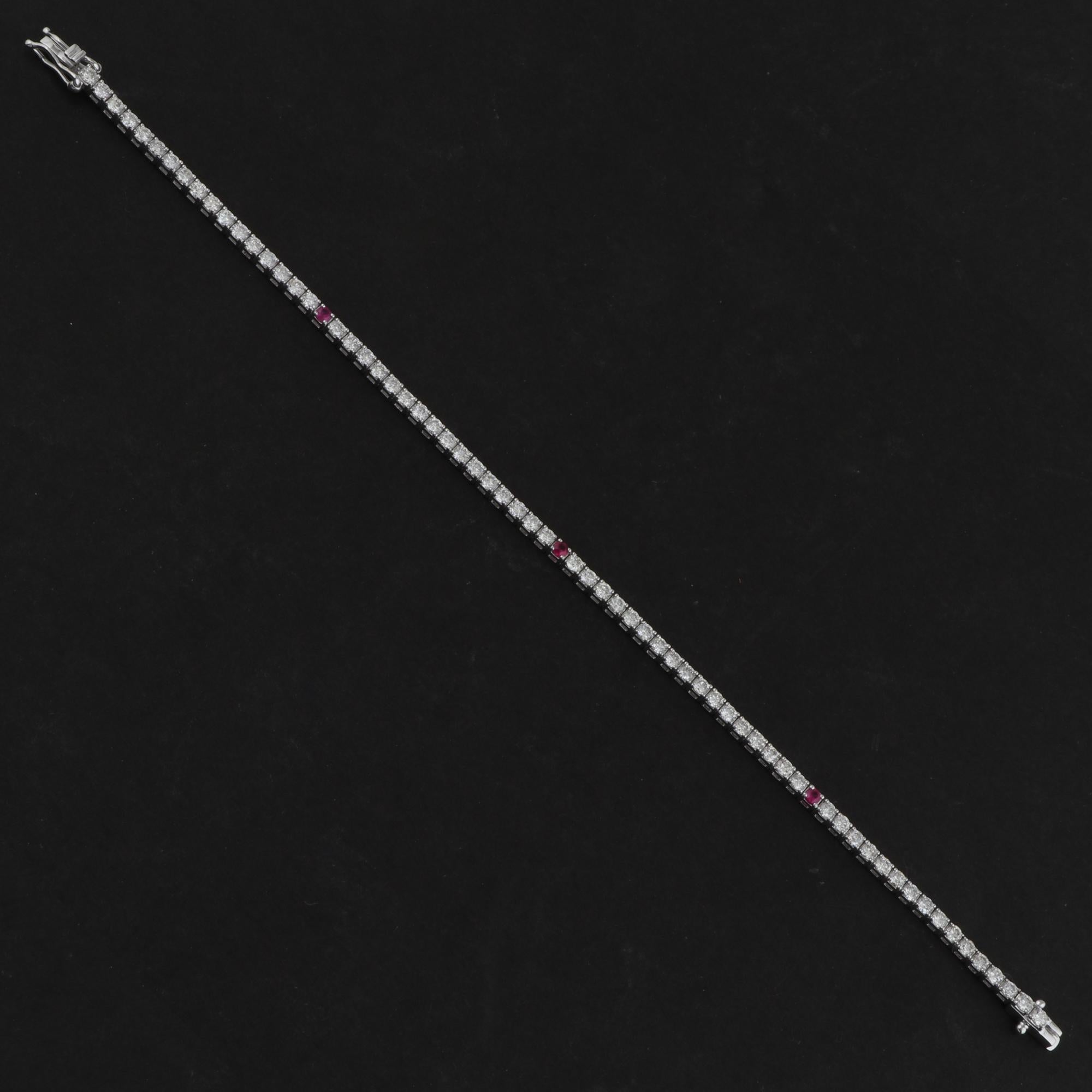 Cast from 18-karat gold, this exquisite bracelet is handset with 0.14 carats of natural ruby and 2.70 carats of sparkling diamonds. Ruby is a July birthstone and is believed to promotes emotional healing and in attracting wealth. A wonderful gift