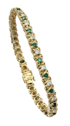 Pulsera con líneas alternas de esmeraldas y diamantes en oro amarillo de 14 quilates