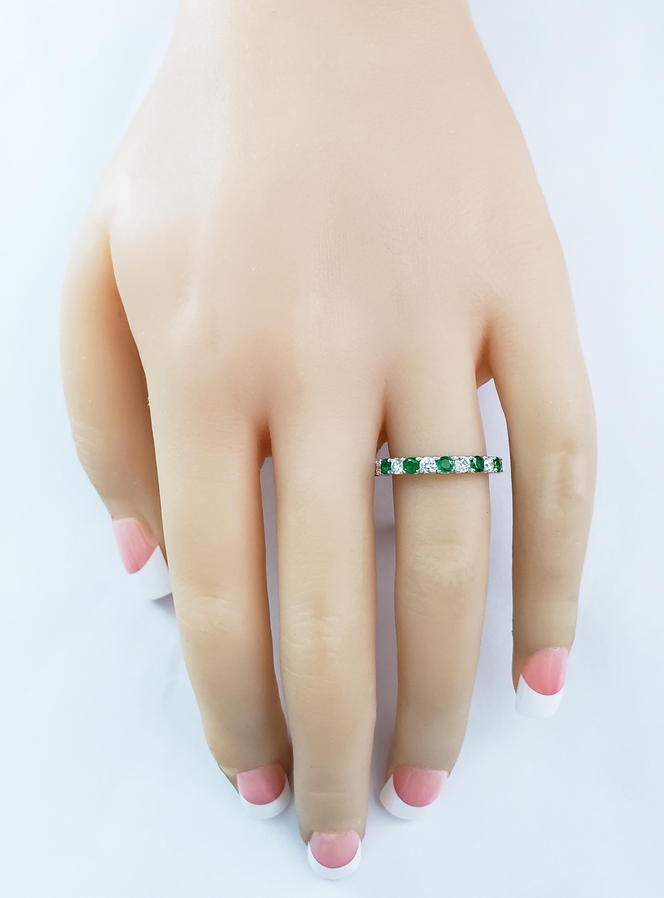 this gorgeous emerald and diamond wedding ring features 7 vibrant green emeralds alternating with 6 brilliant diamonds, all securely set in a french pave style setting. Fashioned in 18 karat white gold. Sizable upon request. 

Style available in