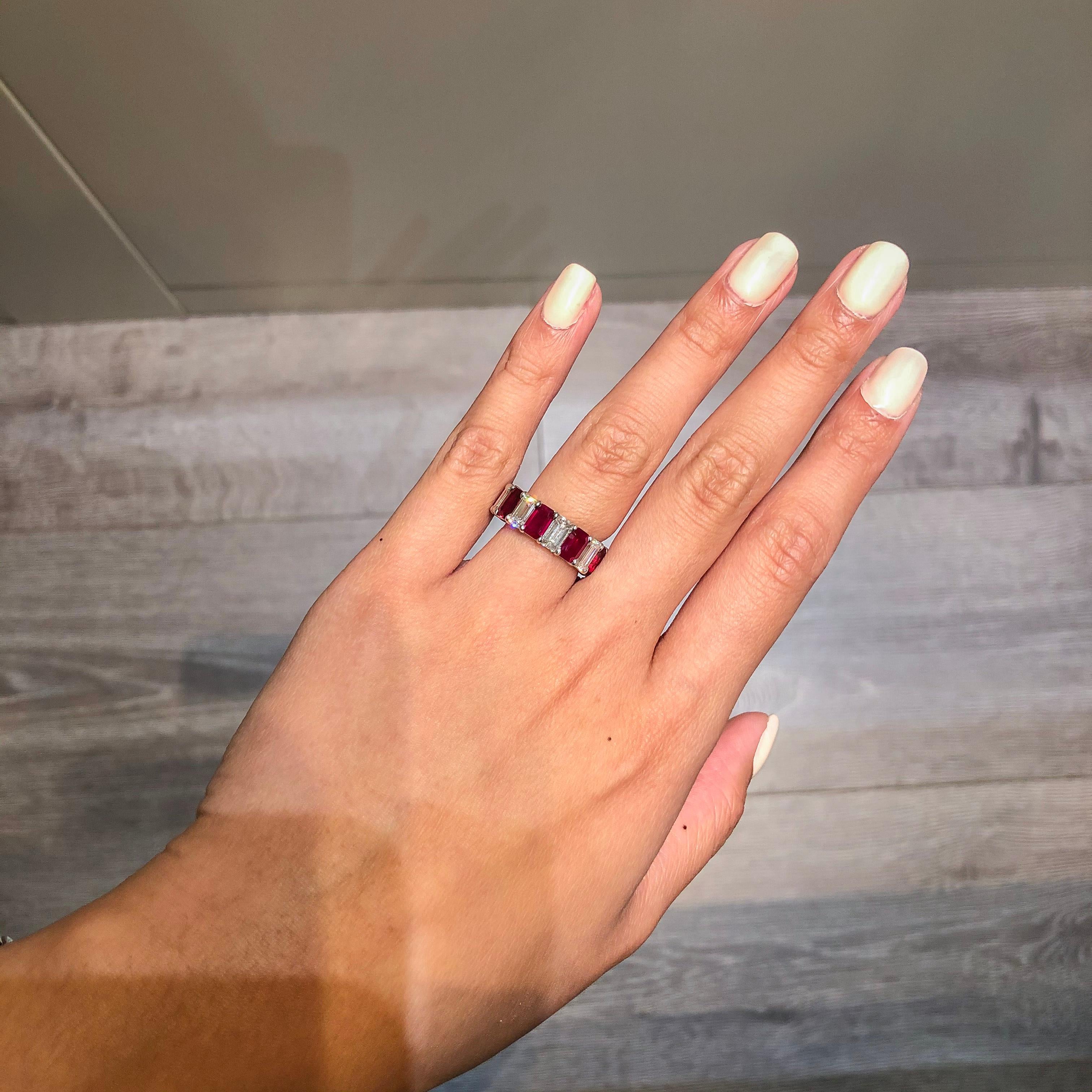 This gorgeous eternity band features 9 natural emerald cut rubies weighing 5.89 carats total that alternate with 9 emerald cut diamonds weighing 4.82 carats total. Set in an eternity style setting. Made with platinum. Approximate size is 6 (limited