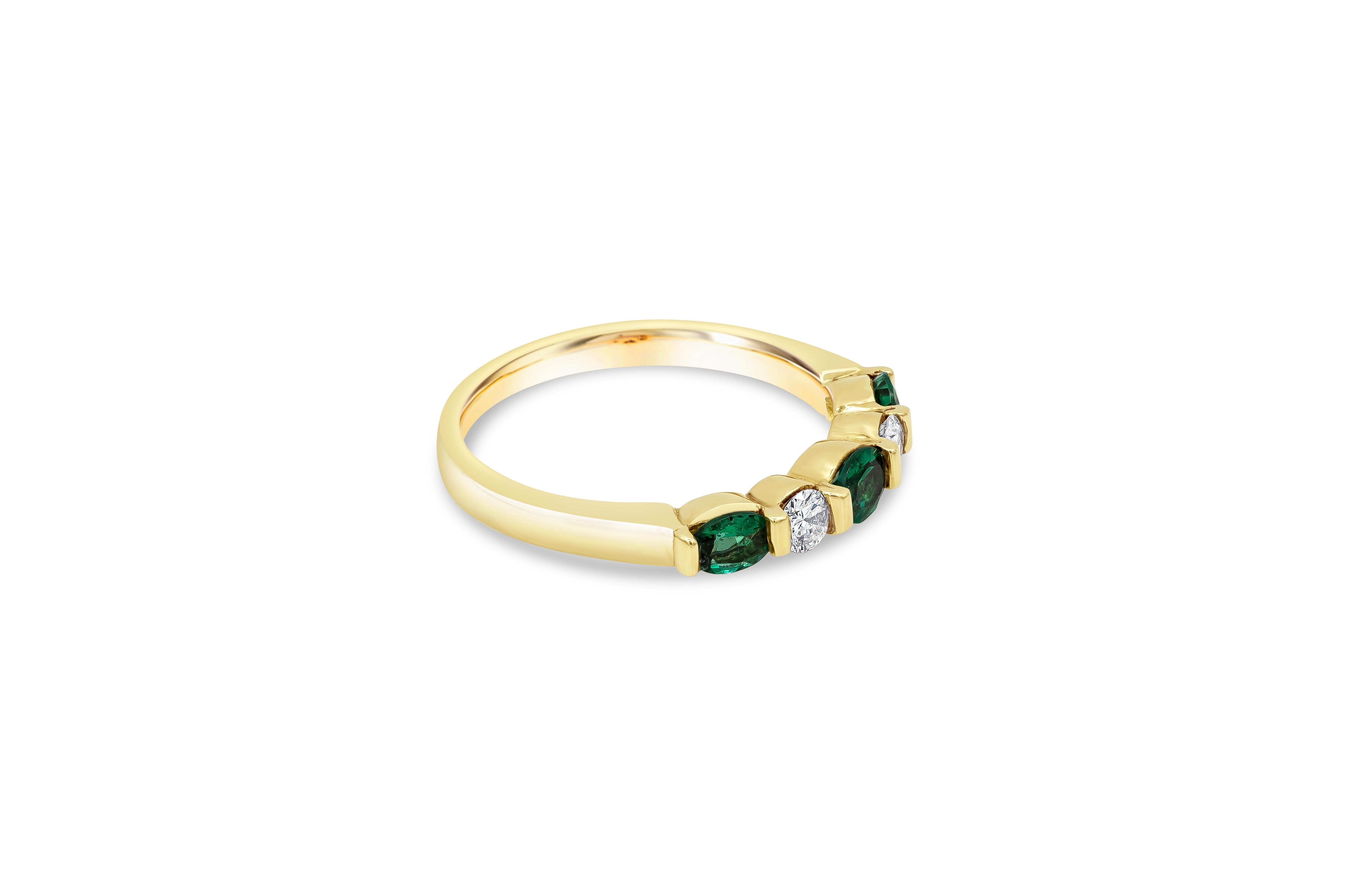 Showcasing three oval cut green emeralds, spaced by round brilliant diamonds in a polished 18k yellow gold. Emeralds weigh 0.35 carats total; diamonds weigh 0.16 carats total. Size 5.5 US (Sizable upon request).

Style available in different price