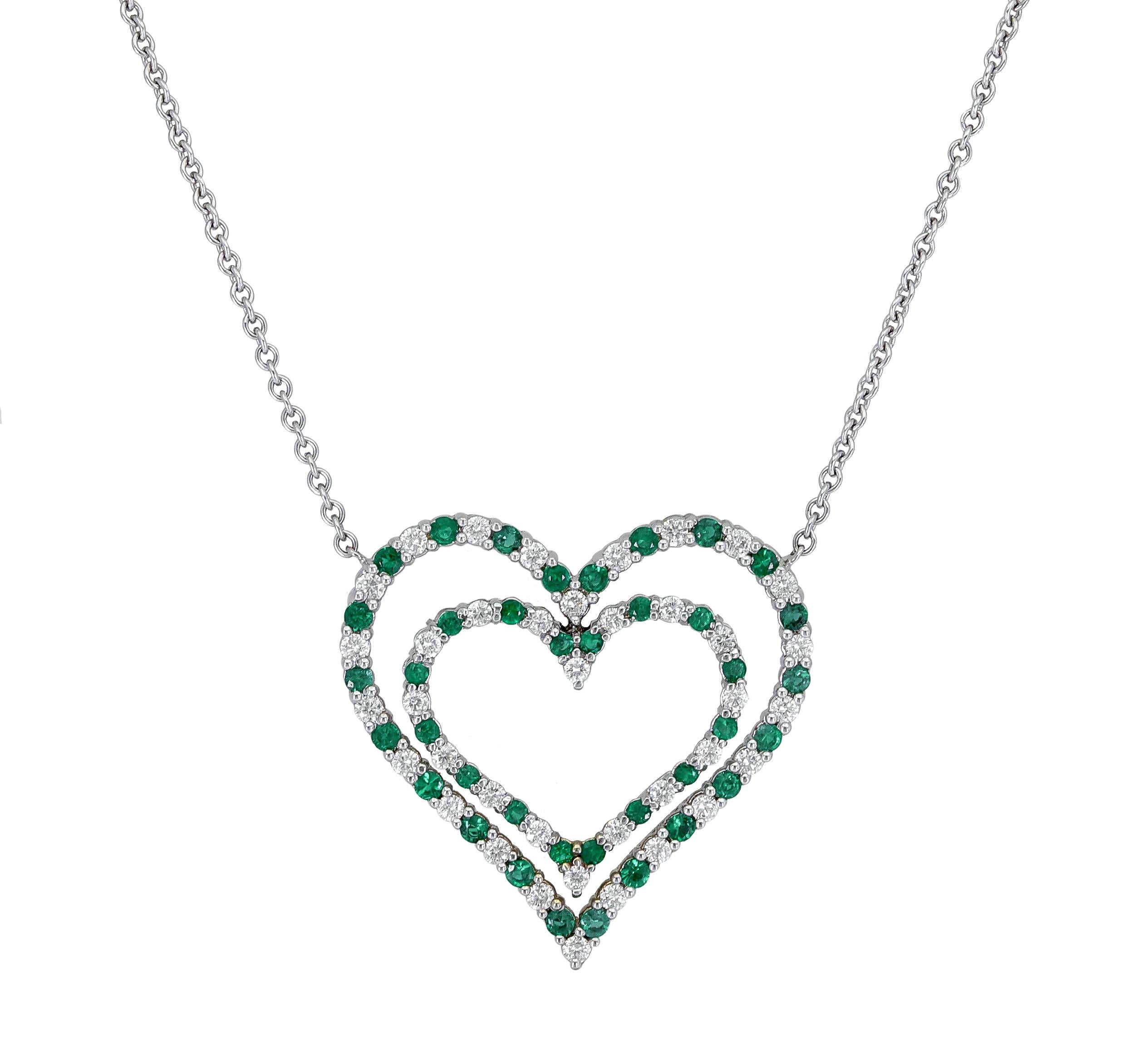 A beautiful open-work design pendant showcasing two rows of alternating green emeralds and diamonds, set in a chic heart shape motif. Made in 18k white gold.
Adjustable 14.5 and 18 inch chain.
Green emeralds and diamonds weigh 5 carats
