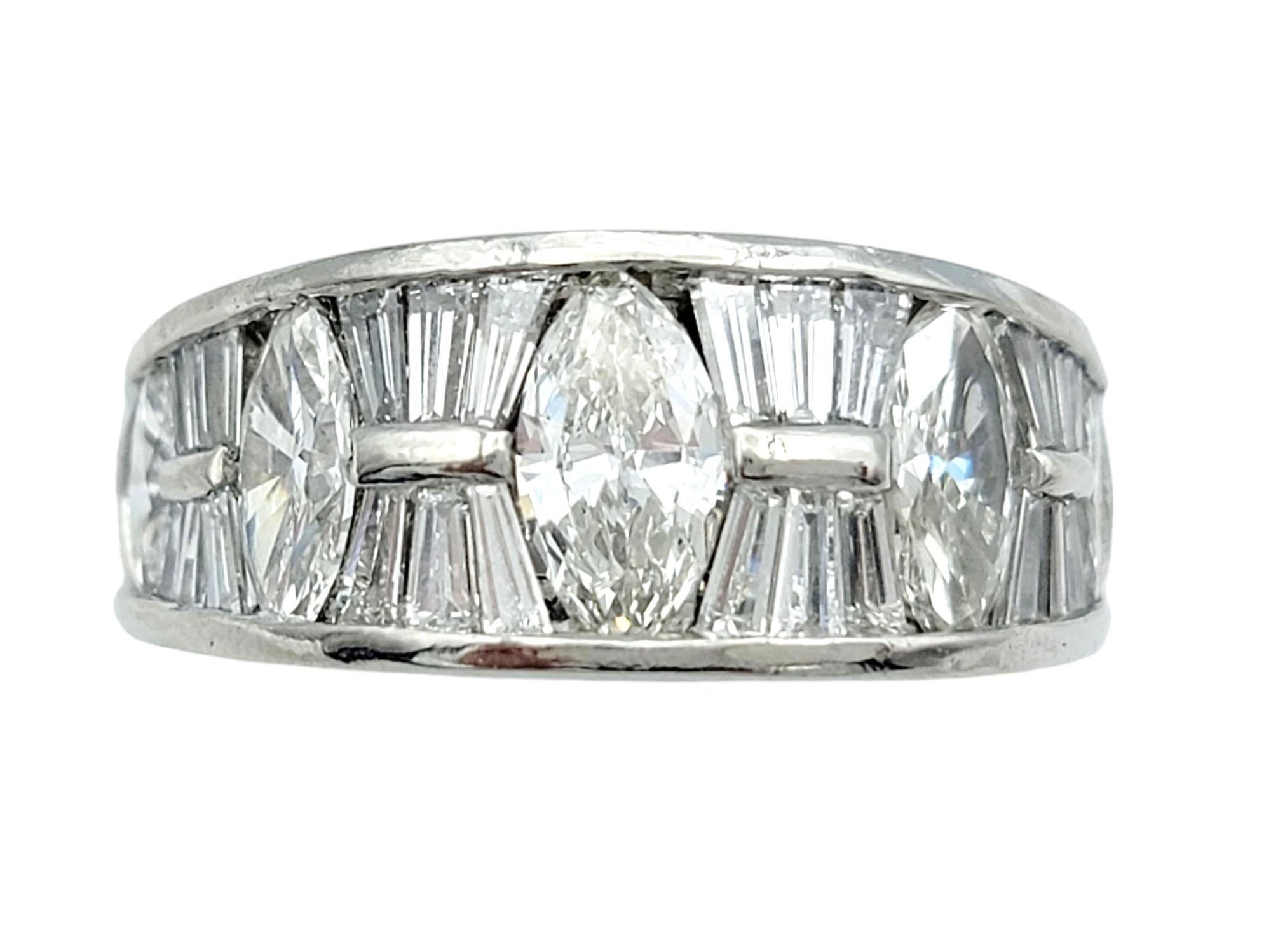 Ring size: 6

This stunning diamond band ring, crafted in luxurious platinum, radiates timeless elegance and modern sophistication. With a total weight of 1.75 carats, the ring features an alternating pattern of brilliant marquise and sleek