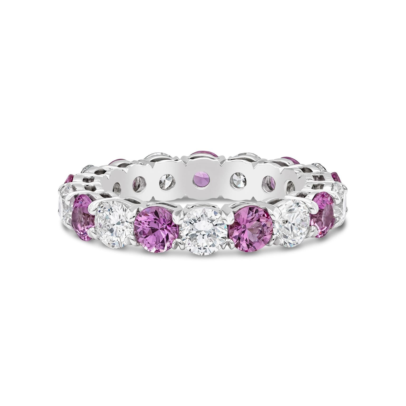 A stylish eternity wedding band features round vibrant pink sapphires weighing 2.38 carats, VS in Clarity, elegantly alternates with round brilliant diamonds weighing 2.20 carats total, F Color and SI in Clarity. Set in a shared prong, open gallery