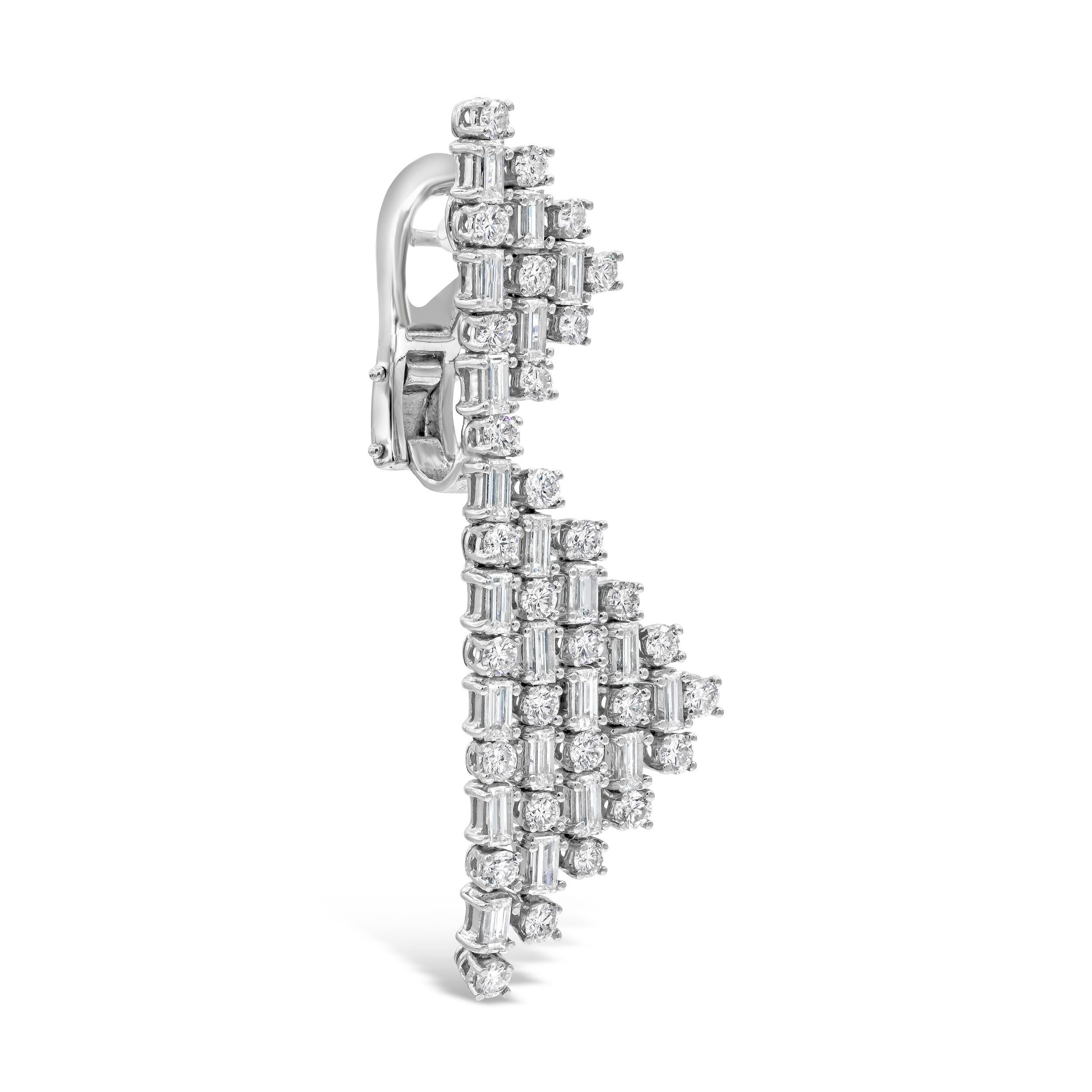 A modern and chic design featuring round diamonds alternating with baguette diamonds, set in a open-work triangular design. Diamonds weigh 7.41 carats total. Made in 18k white gold. Omega Clip with post. Has a matching necklace.

Style available in
