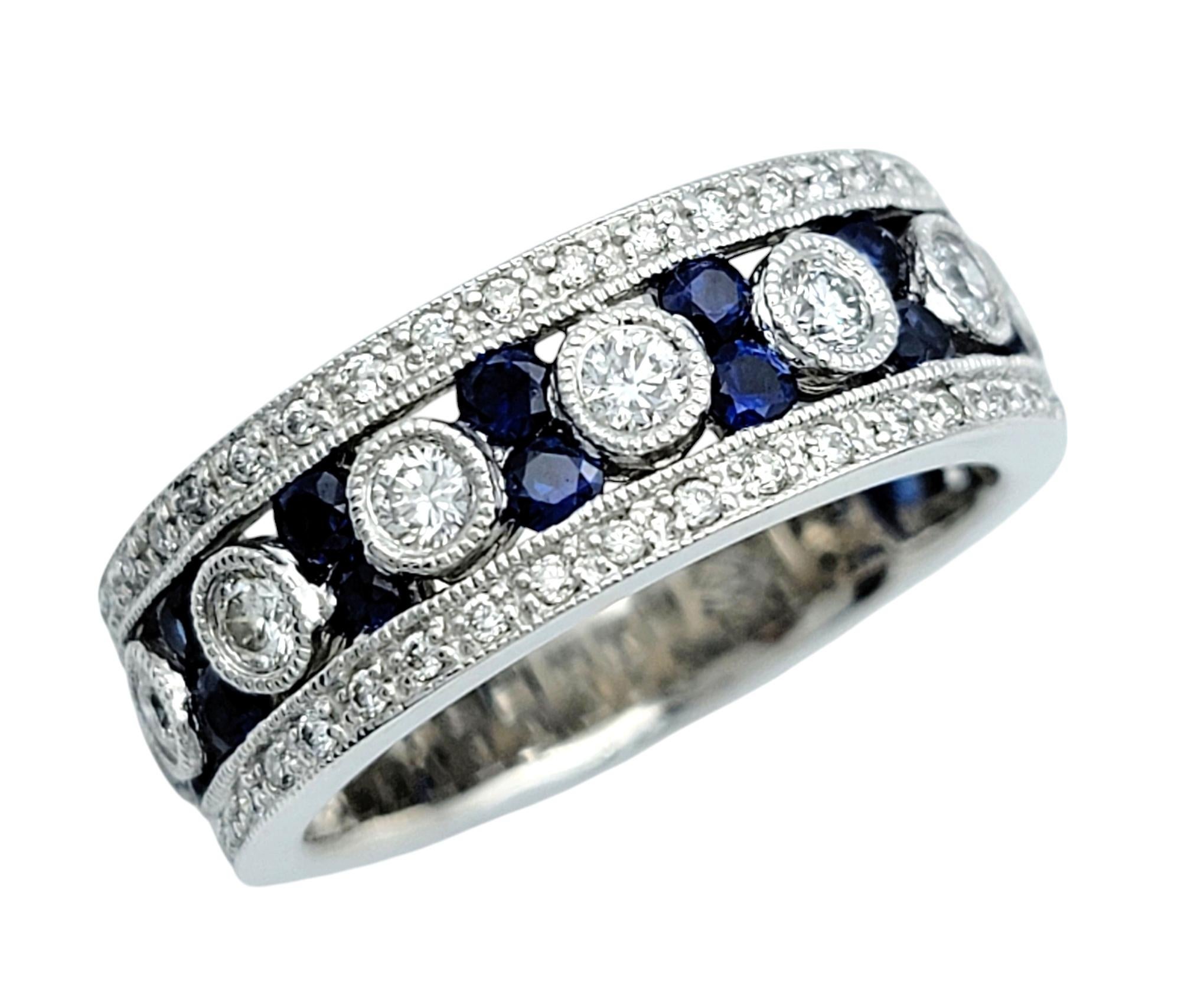 Ring Size: 7

Experience the epitome of elegance with this breathtaking 14 karat white gold band that radiates timeless sophistication. At its heart lies a row of bezel-set round diamonds, each stone shimmering with unmatched brilliance. Encircling