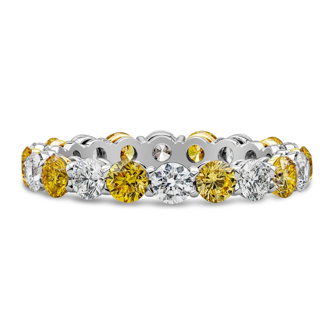 A fashionable eternity wedding band that can complement an engagement ring, or used as a stand-alone piece. Showcasing Fancy Vivid Yellow diamonds weighing 1.33 carats total, VS-Si in Clarity. Alternating with round brilliant white diamonds weighing