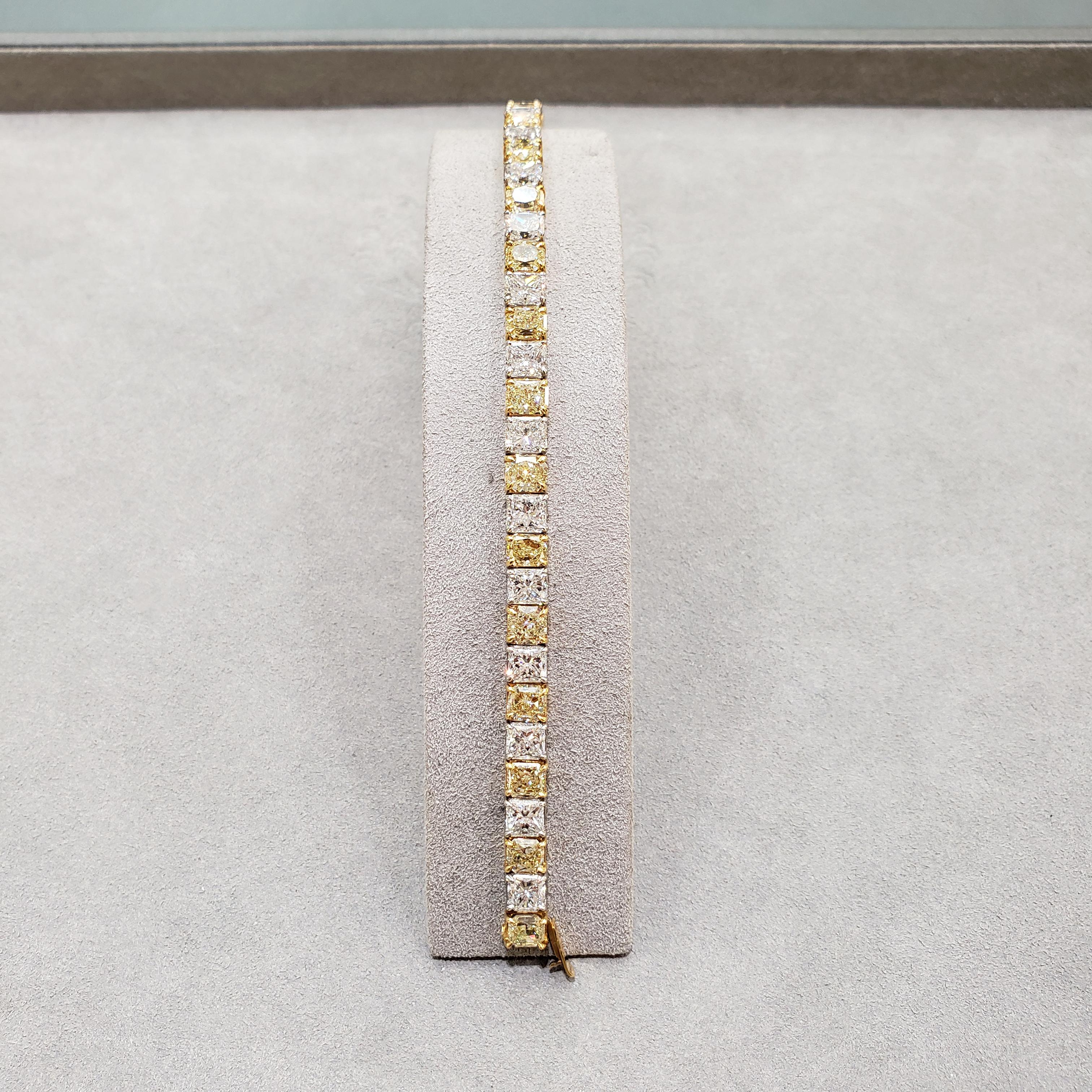 An absolutely stunning tennis bracelet that will catch everyone's attention. Features an outstanding 32.56 carats of brilliant radiant cut diamonds; 17 radiant cut yellow diamonds weighing 17.22 carats and 16 radiant cut white diamonds weighing