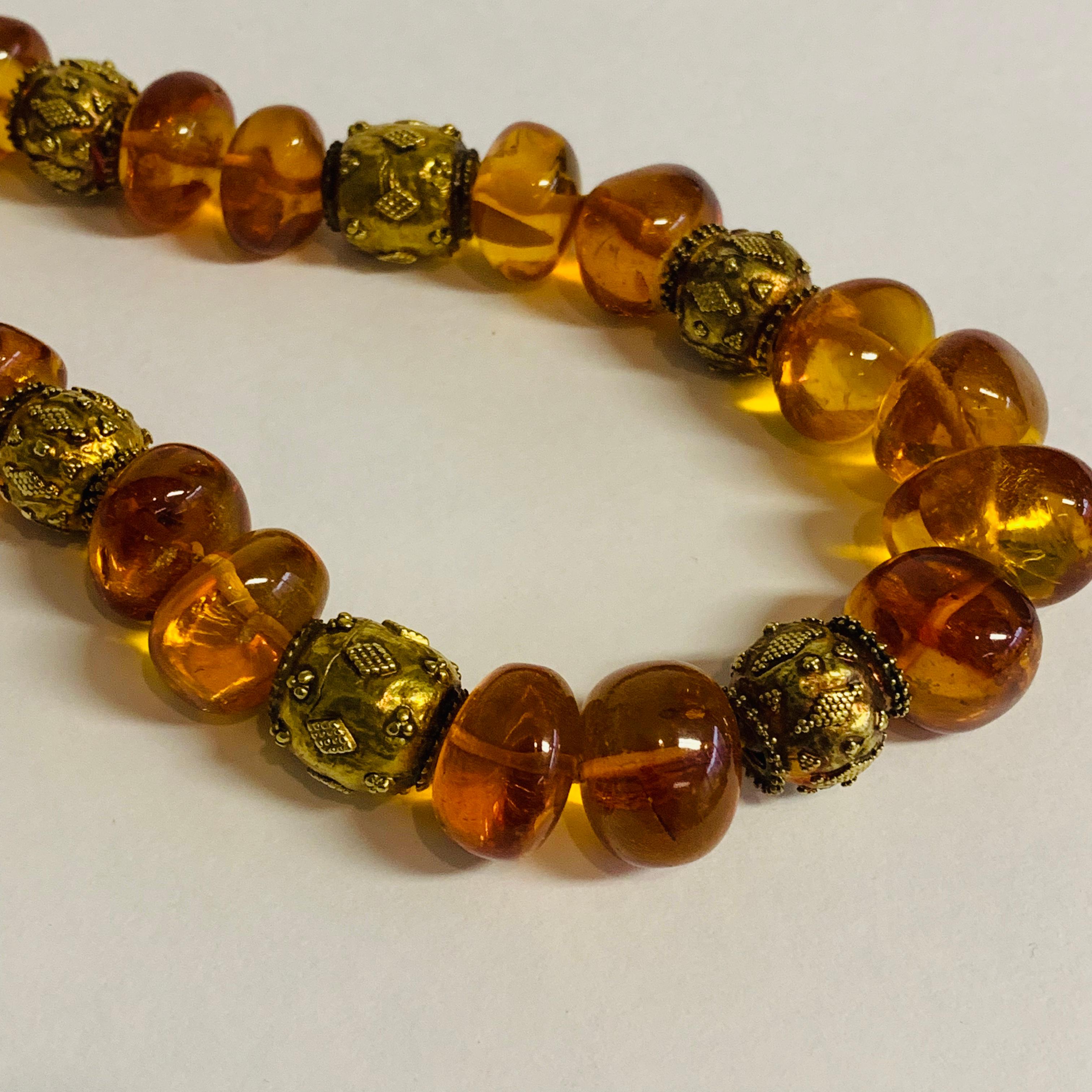 This beautiful necklace of large graduated Baltic amber beads is mixed with stunning old Indian 18k gold decorative beads.  A unique and highly artistic piece incorporating the work of fine artisan goldsmiths.

Designed by AMANDA CLARK for Altfield,