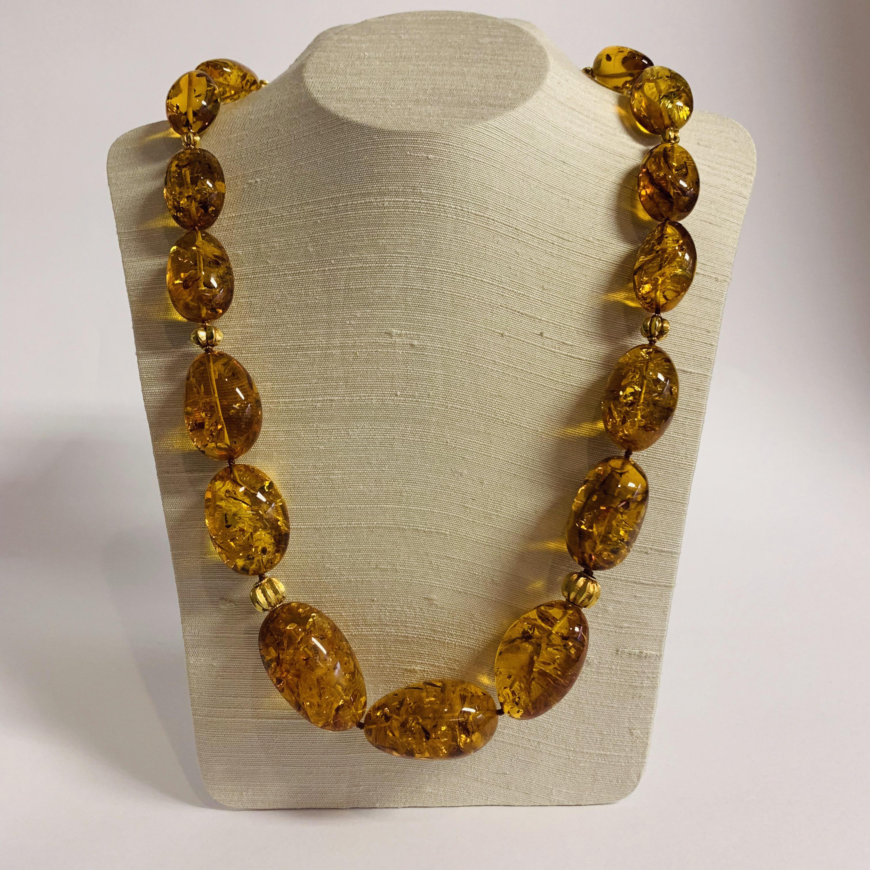 This lovely necklace of graduated deeply coloured oval Baltic Amber beads, is further accented by old 18k Gold hand-crafted ribbed Indian beads.

Designed by AMANDA CLARK for Altfield, our collection focuses on natures most lovely materials such as