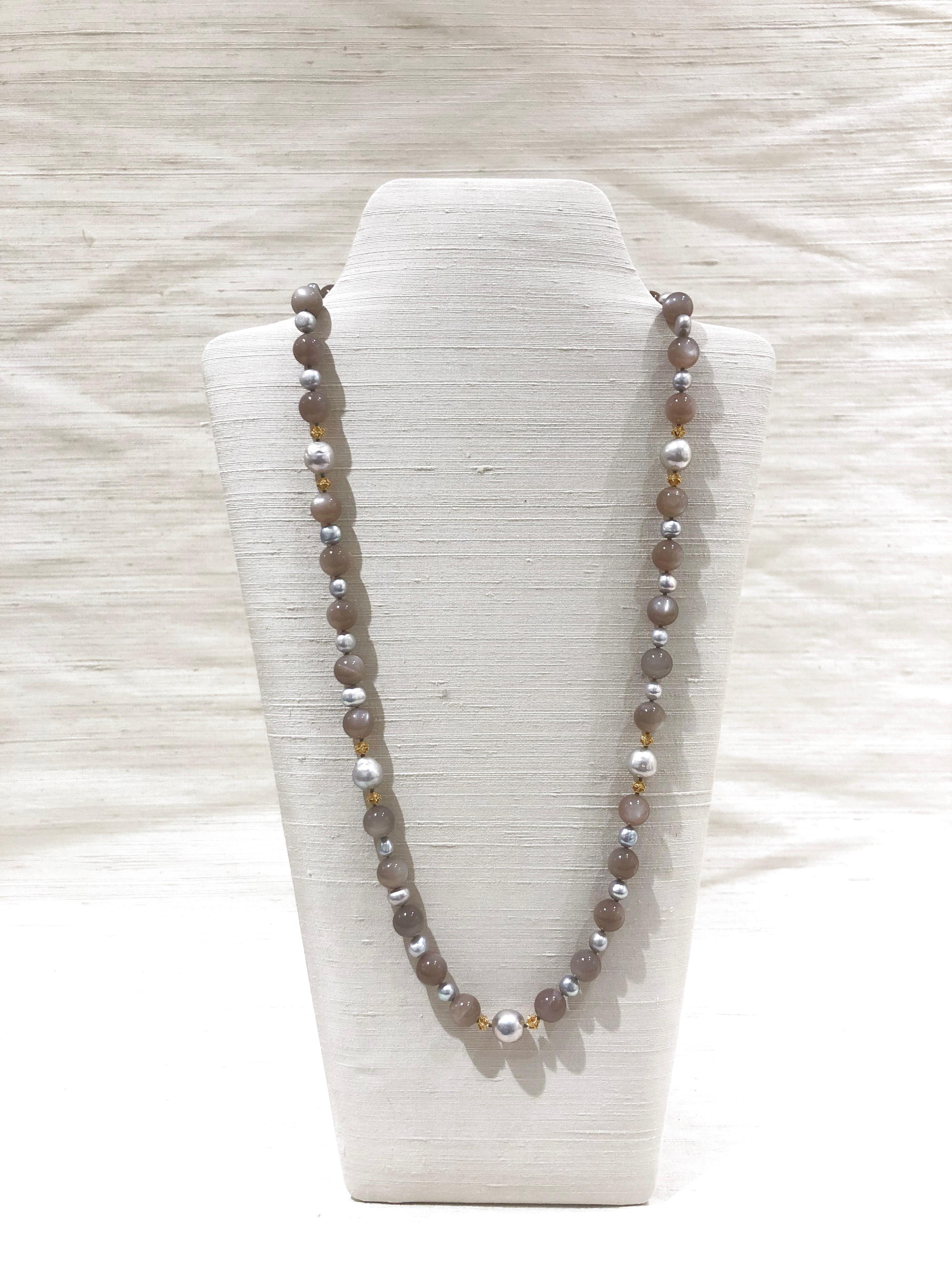 31 in (78.5cm) necklace with grey moonstone, freshwater pearls and 18K gold beads. 
A beautiful long necklace with lustrous soft grey moonstone beads enhanced by freshwater pearls and rhombus form 18 K gold beads.

