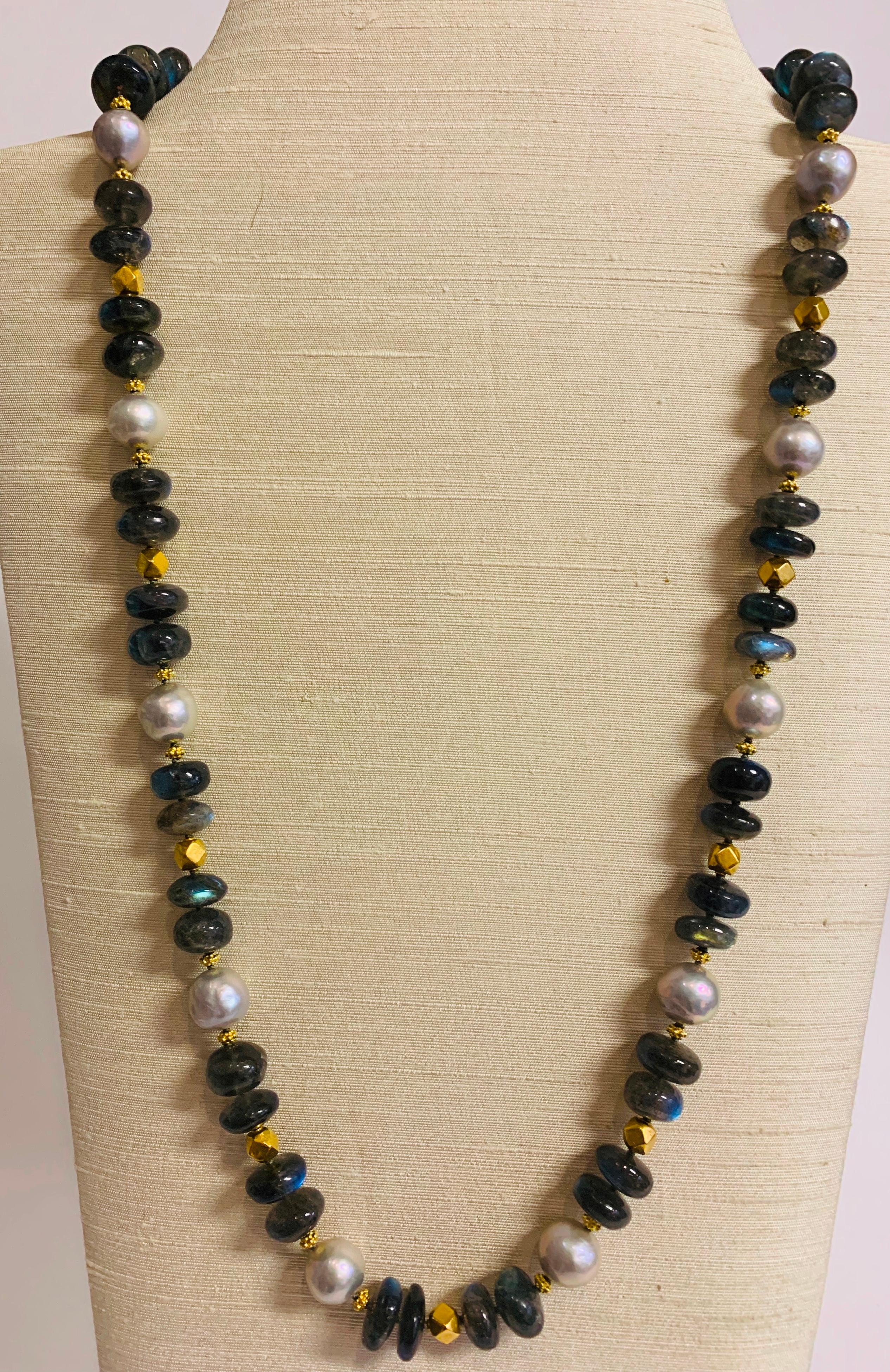 A wonderful necklace of multi-faceted reflective labradorite beads mixed with freshwater pearls and 18k gold beads to create a glamorous piece well suited to evening wear.

Designed by AMANDA CLARK for Altfield, our collection focuses on natures
