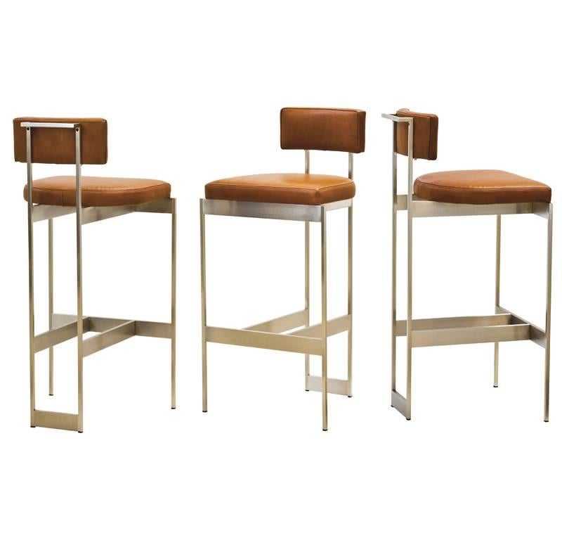Counter height leather stool with sculptural plated or powder coat metal frame with nylon glides. Tightly upholstered seat and back with top-stitched seams. Measures: Seat height is 26