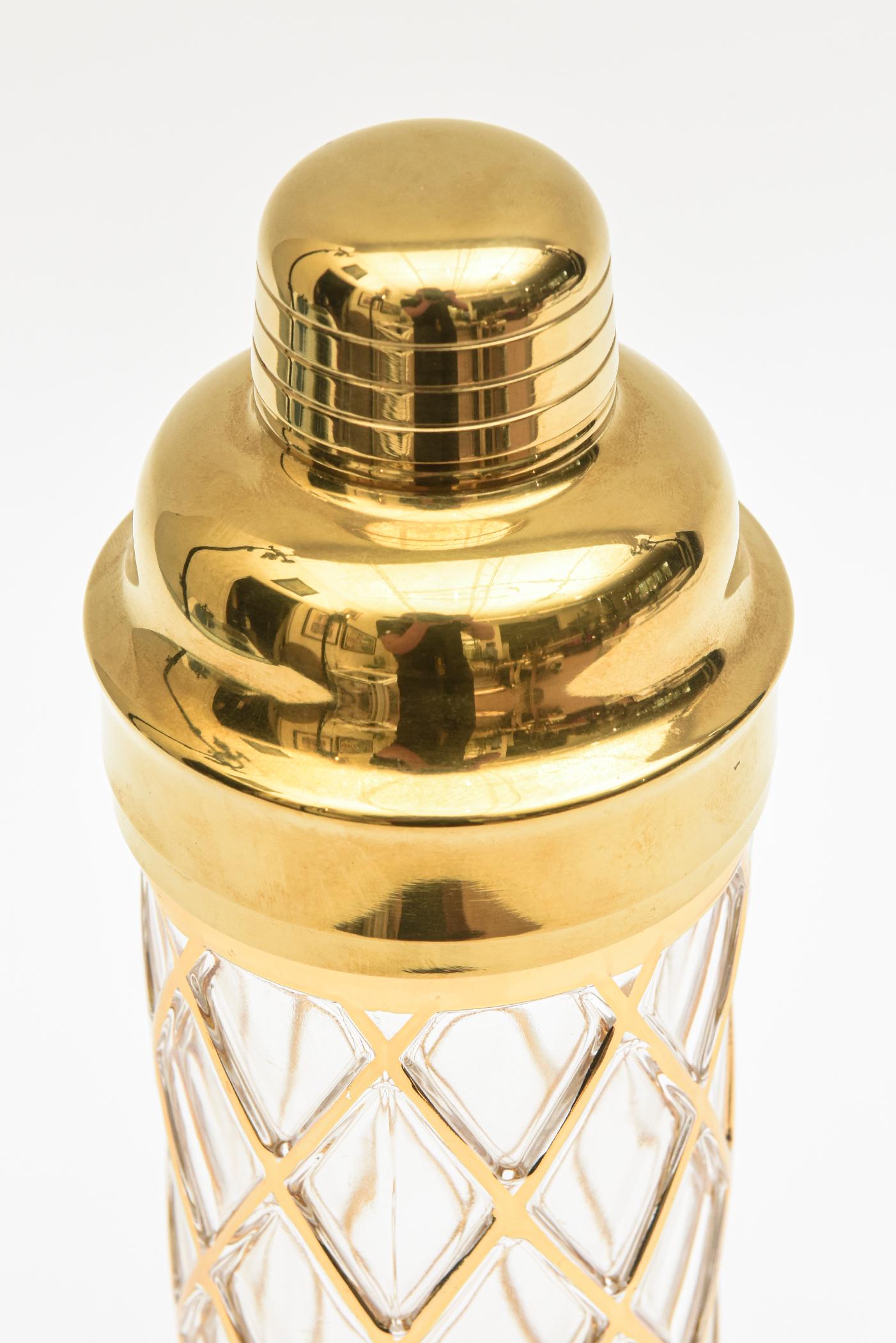 This chic 18 K gold overlay of a diamond pattern over glass cocktail shaker is signed Altuzarra. It is from 2010. Joseph Altuzarra is a well known and coveted fashion designer who started and launched his brand in NYC in 2008. He had a very multi
