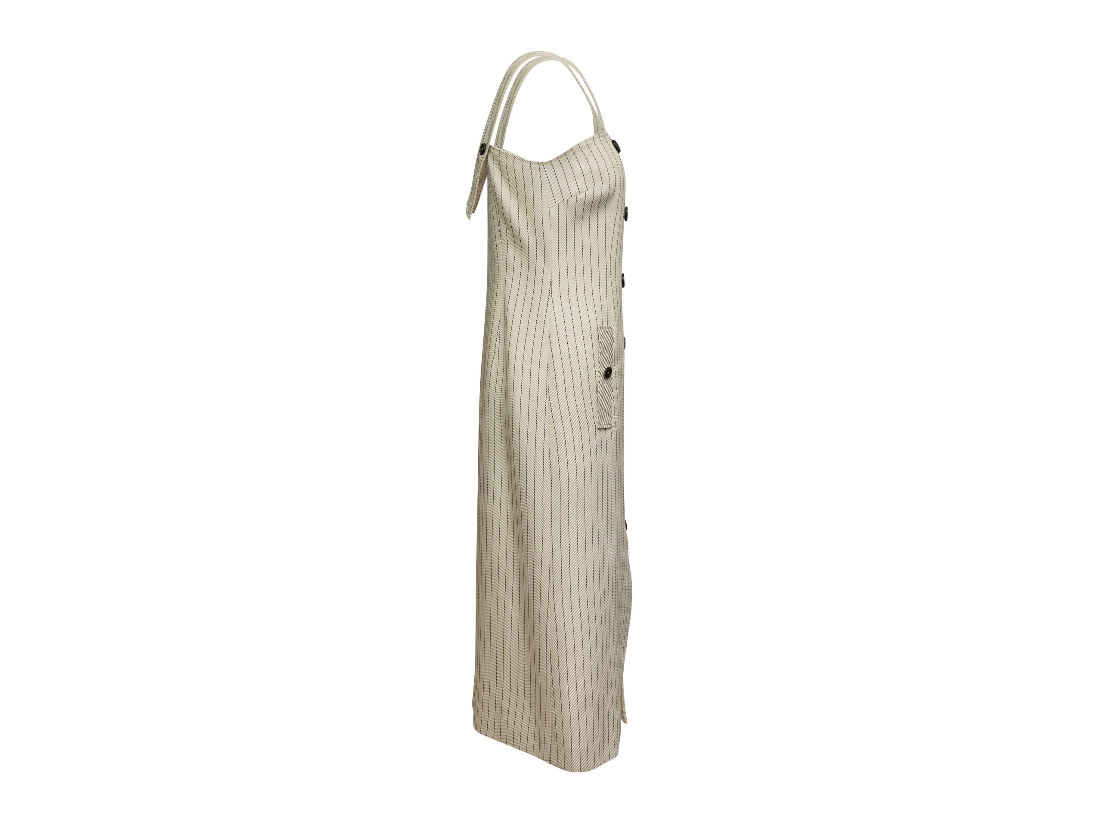 Product details: Cream and black pinstriped sleeveless dress by Altuzarra. Double-breasted button accents at front. Dual pockets. Adjustable straps. Designer size 40. 31