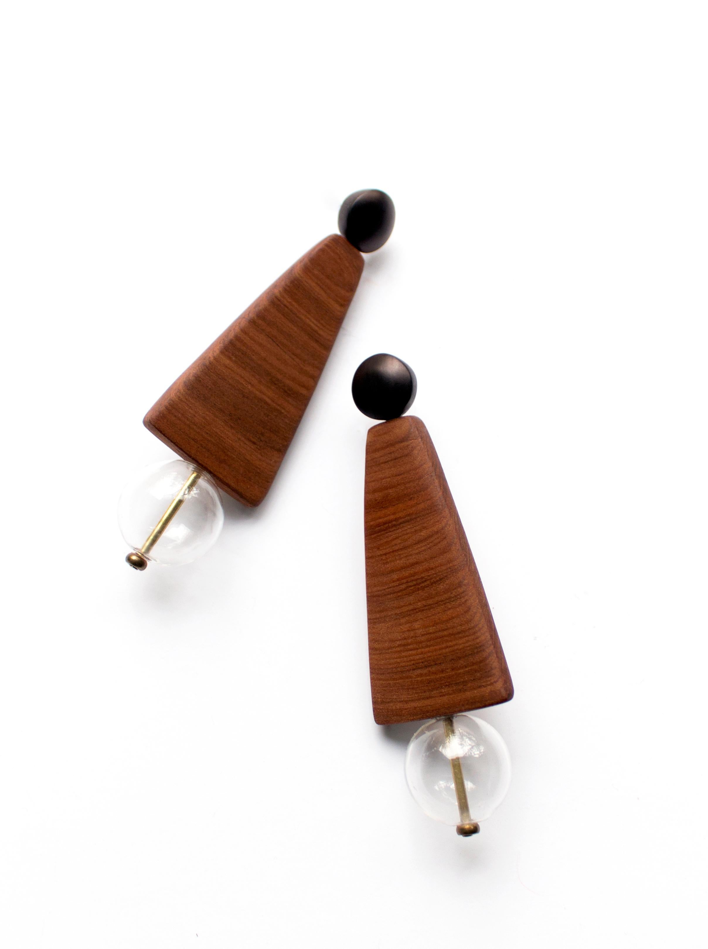 Hand-carved reclaimed wood earrings inspired by mid-century artists such as George Nakashima.    
Rich grained black walnut wedges and affixed blown glass beads suspended from hardwood studs.  Hypoallergenic stainless steel posts. 

All Hola Luna