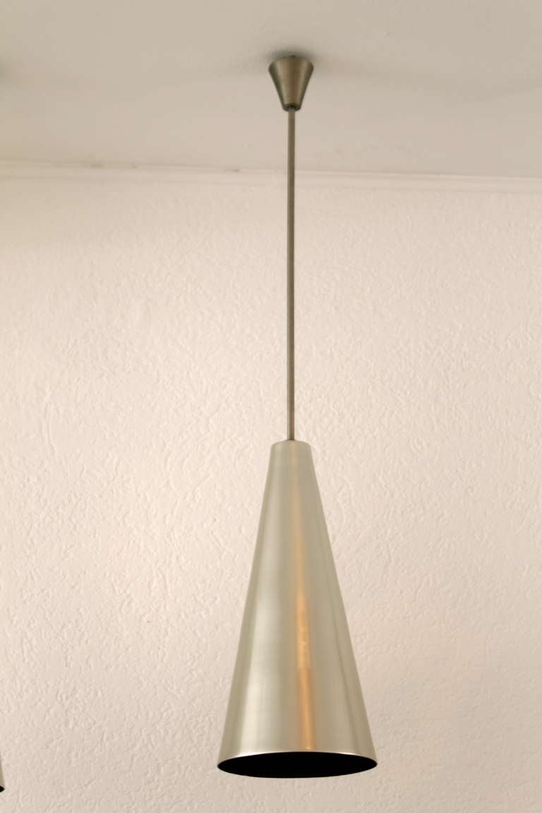 Alumag Belmag three aluminum cone shape pendant lamps

Nice quality, Alumag labels under the shades. Very good condition.