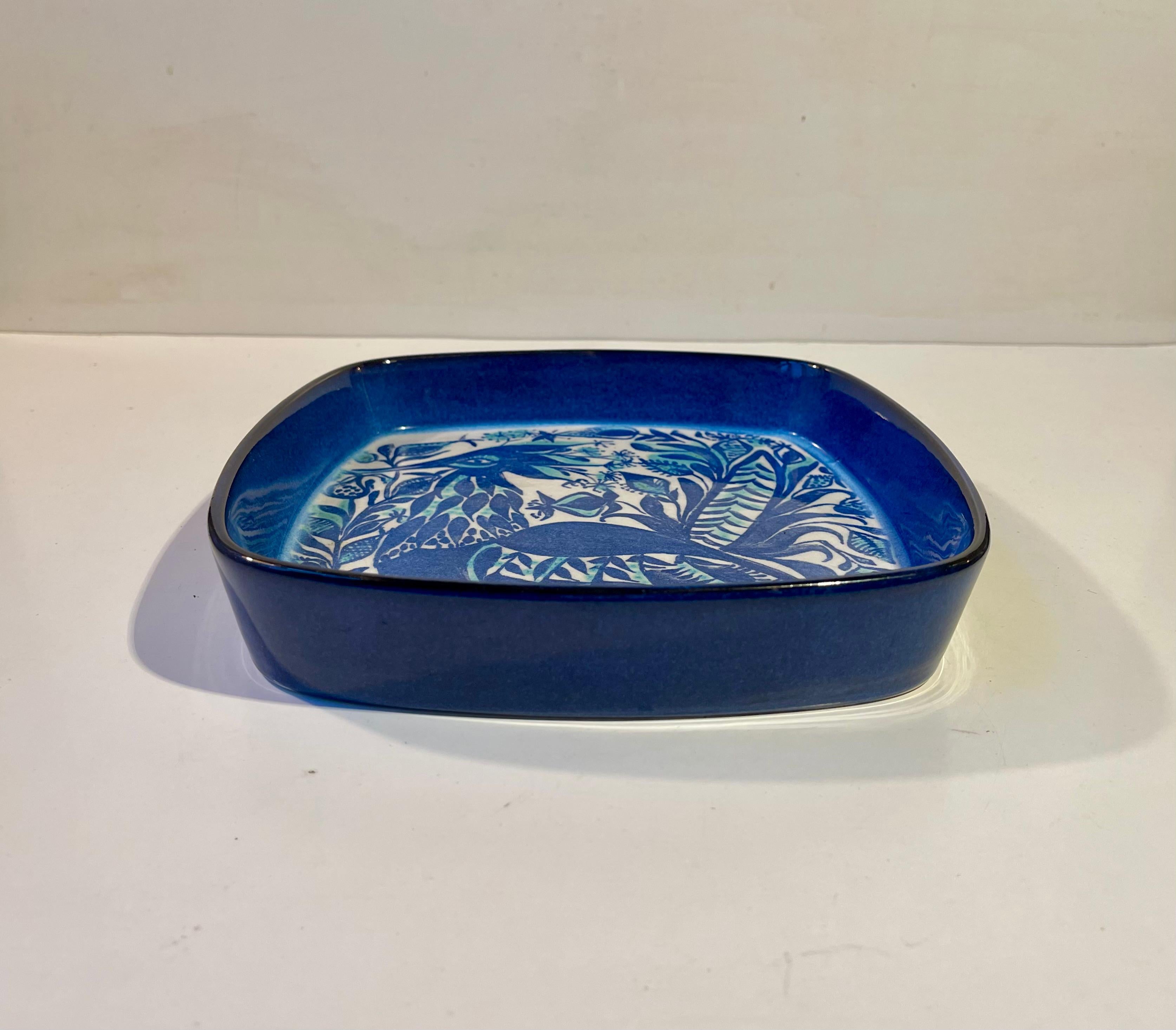 Aluminia Denmark Art Faience bowl designed by Marianne Johnson. A series of artist faience initiated by Nils Thorsson. Its. Ddecorated with a blue fantasy bird. Model number 143/2884.Its fully marked to the base with designer initials and makers