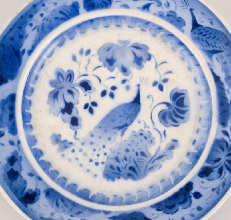 Mid-20th Century Aluminia, Denmark. Oval dish and two plates in faience. Peacock pattern. For Sale