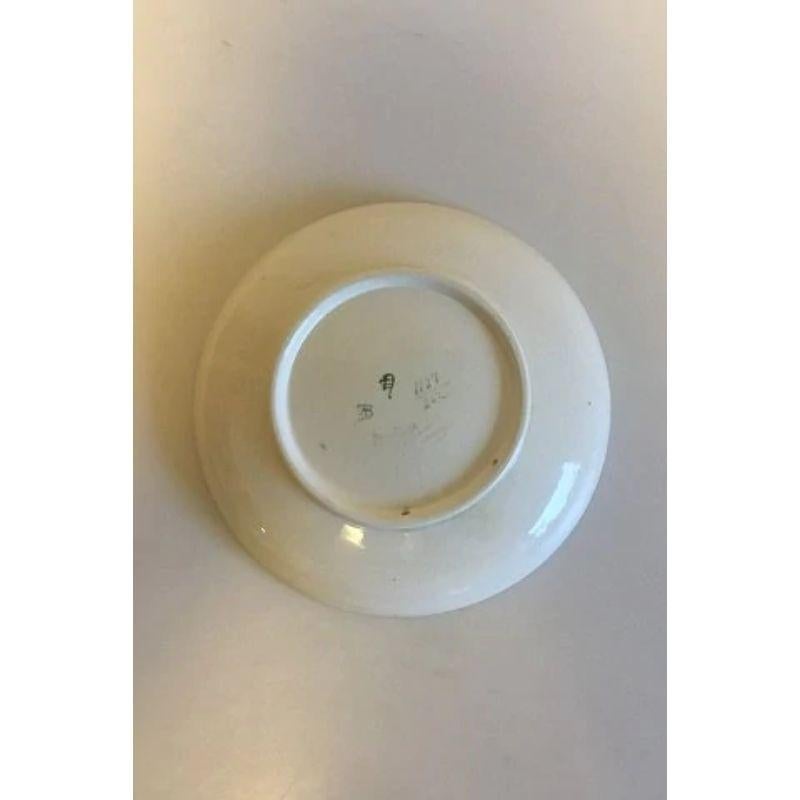 Aluminia Juliane plate from 1917.

Measures 24.5 cm / 9 41/64 in. and is in good condition. Small cracks in the glaze can be found. Like on most items made in Faience.

The series runs from 1909 through 1921. Made for the occation of the birth