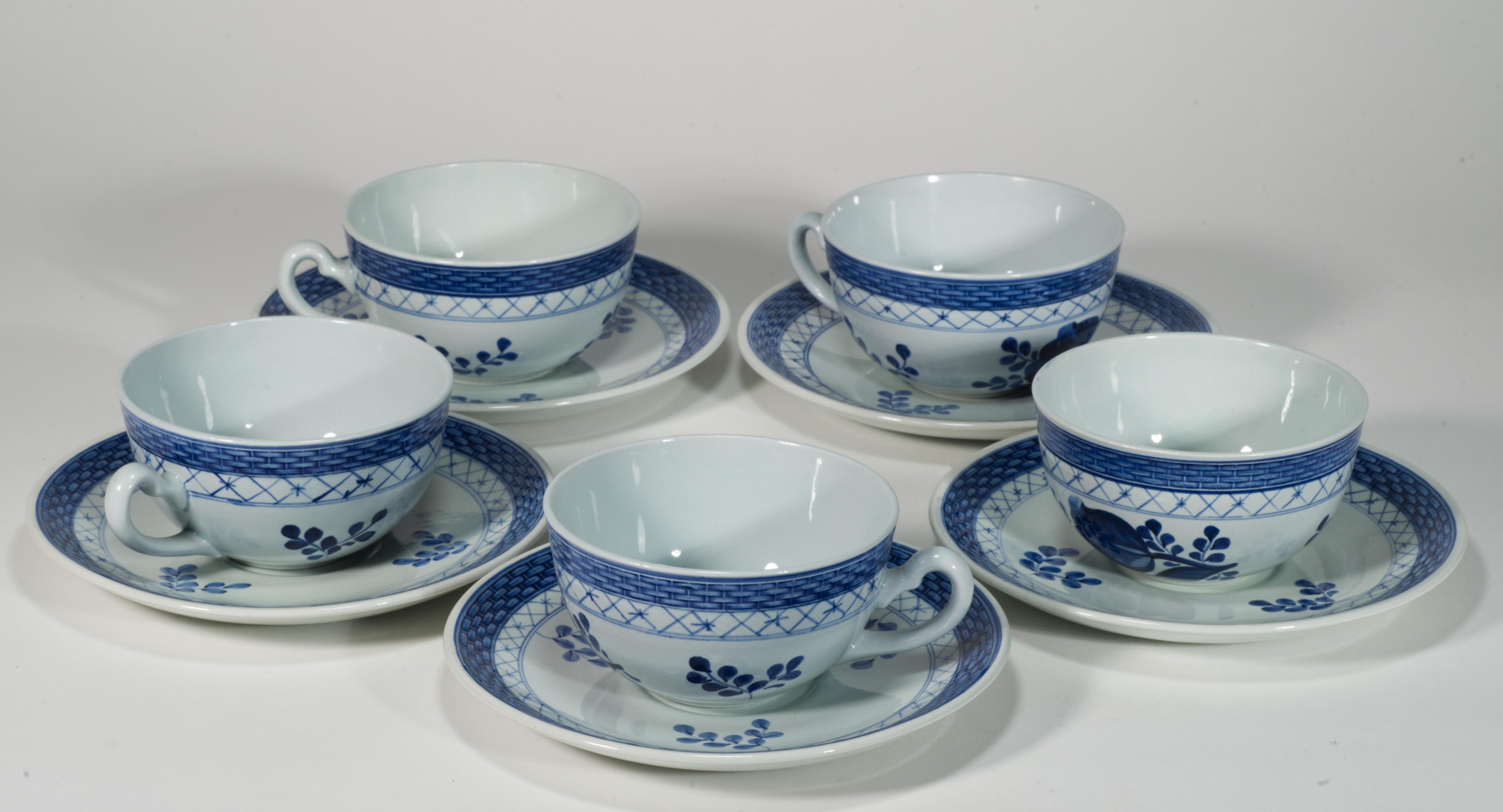  Vintage set of 5 cups and 5 saucers features the main motif of a tulip framed by a braided pattern in blue colors. The braided rims of both cups and saucers are done in relief, adding texture to otherwise minimally shaped pieces.

The cups and