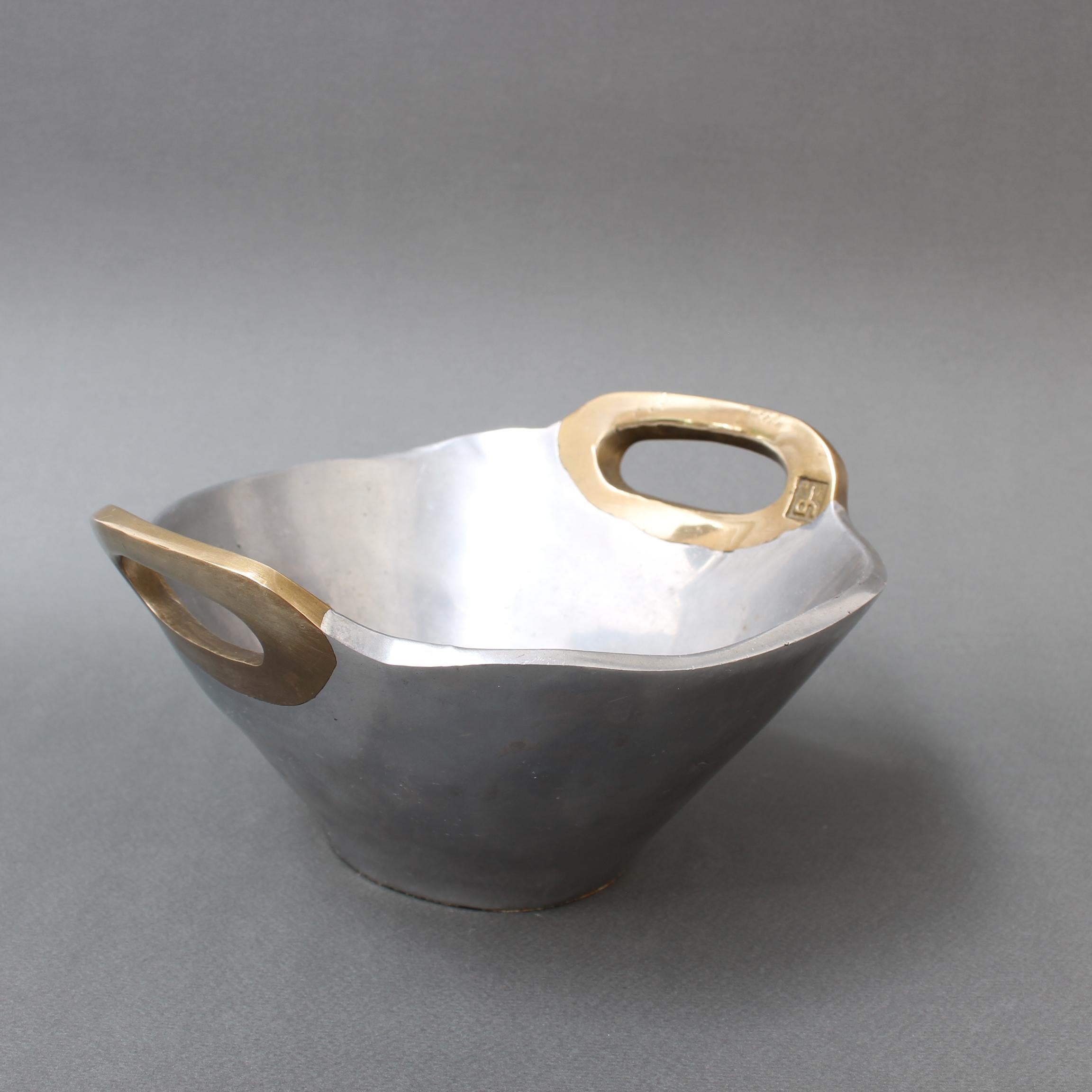 Aluminium and brass bowl by David Marshall (circa 1980s). A stunning piece, Its solidity and heft are reassuring and its tactility, sensuous. The maker's mark is impressed on the inner surface of the brass handle. The underside has the trademark