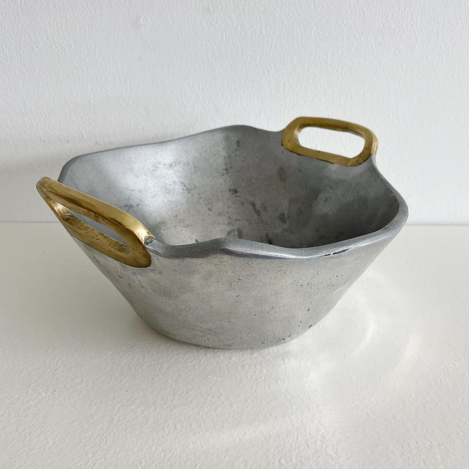 Brutalist style, mid century, solid aluminum bowl with double brass handles by Scottish artist David Marshall. The maker's mark is impressed on the inner surface of the higher brass handle. The bottom has the trademark leather base also with maker's