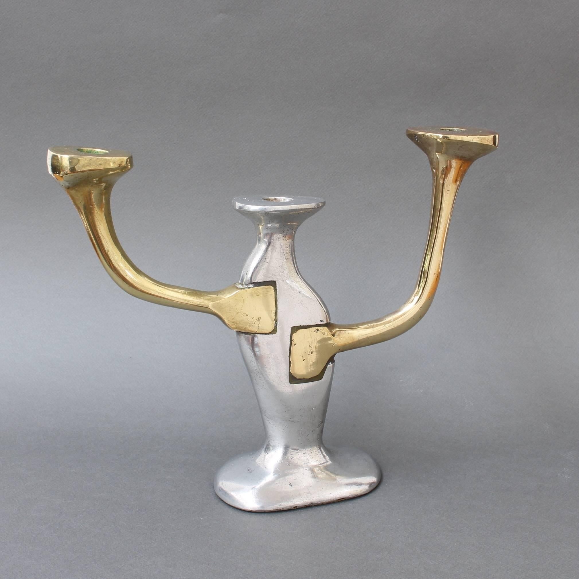 Aluminium and brass candleholder by David Marshall, circa 1970s. This candleholder appears to be inspired by Gaudi in that it seems imperfect or irregular. Therein lies its beauty. Like branches emanating from a tree the candle stems grow according