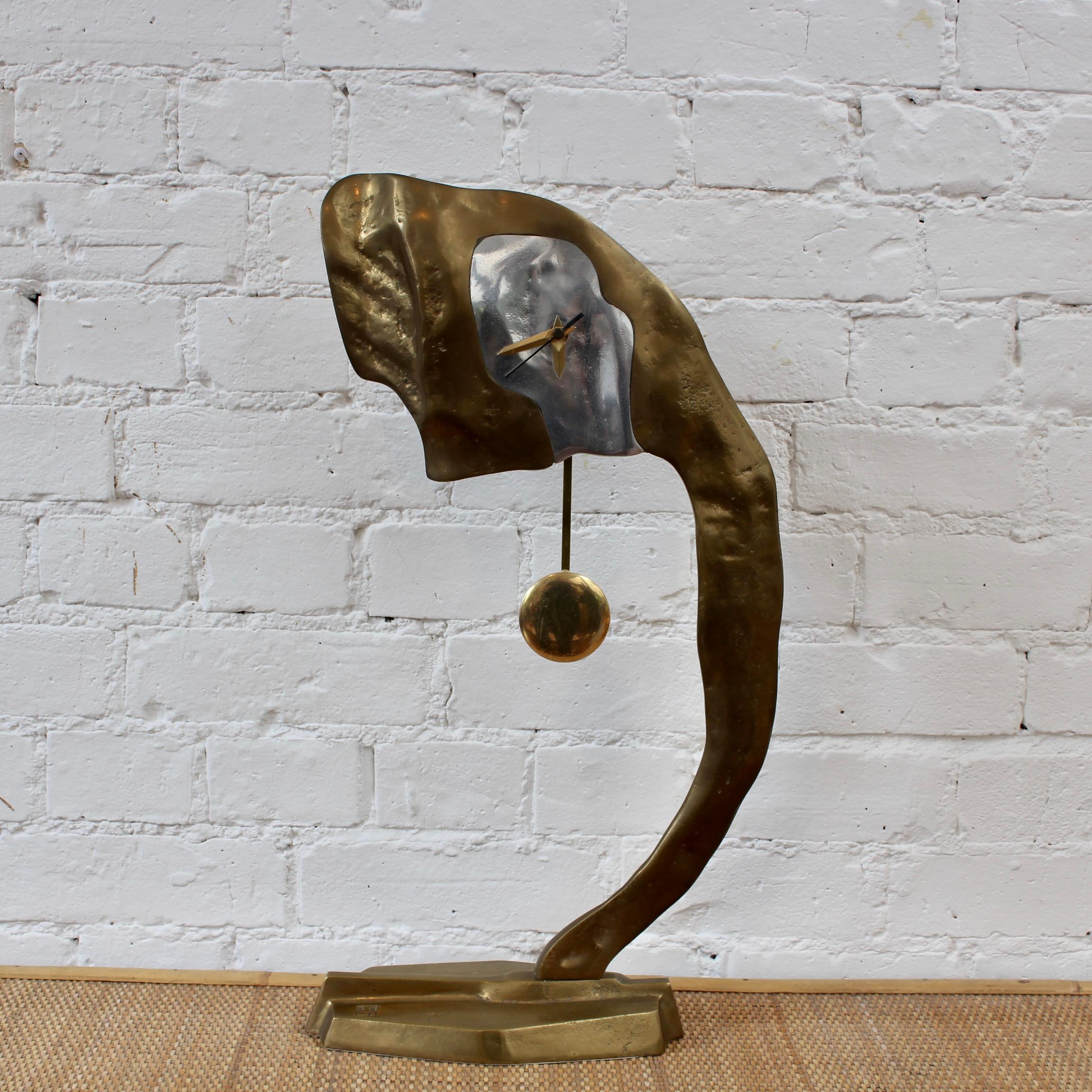 An aluminium and brass brutalist style decorative clock by David Marshall (circa 1980s). The piece is weighty and wonderfully tactile with the maker's mark impressed on the clock's base. Like all of David Marshall's works this one is also elegantly