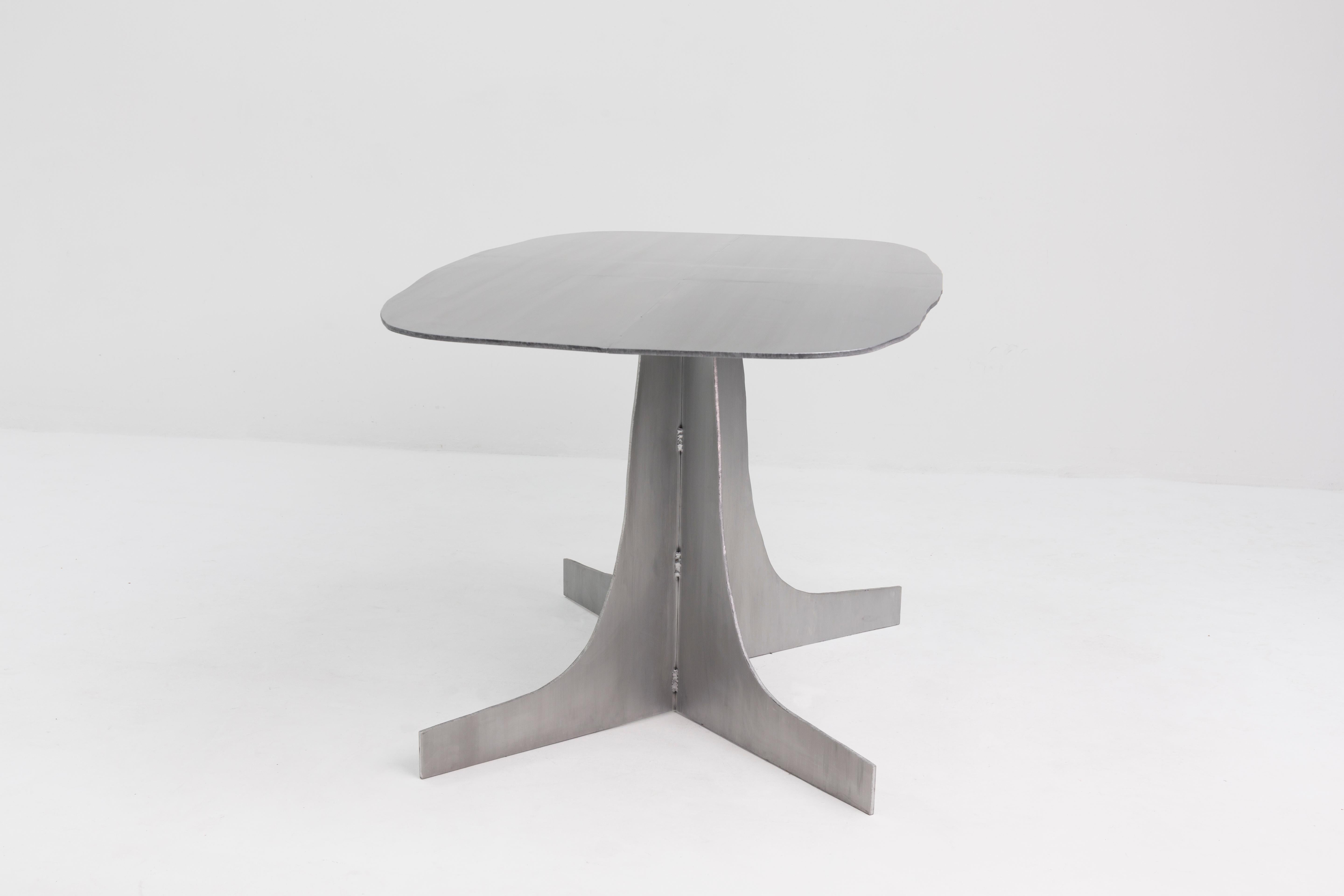 Aluminium Rational Jigsaw Table by Studio Julien Manaira
Dimensions: 84 x 150 x 75 cm
Materials: Brushed and Waxed aluminium

The intention behind this project is to highlight the traces from the actions of the maker. In this sense, the choice of