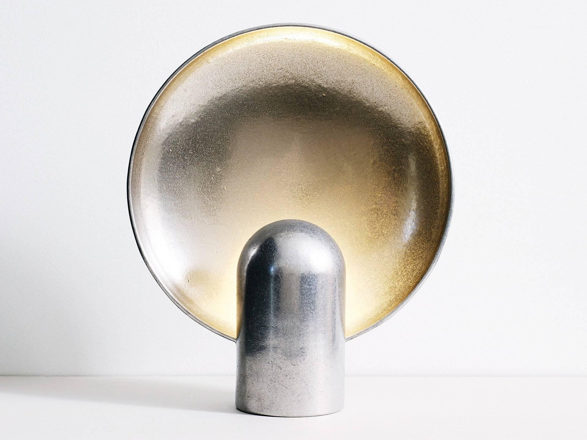 The surface sconce is a ambient, sculptural light cast in two halves from solid gunmetal. 

Each casting is manufactured in small batches meaning slight variations will occur from piece to piece. Production marks may include slight pour ripples or