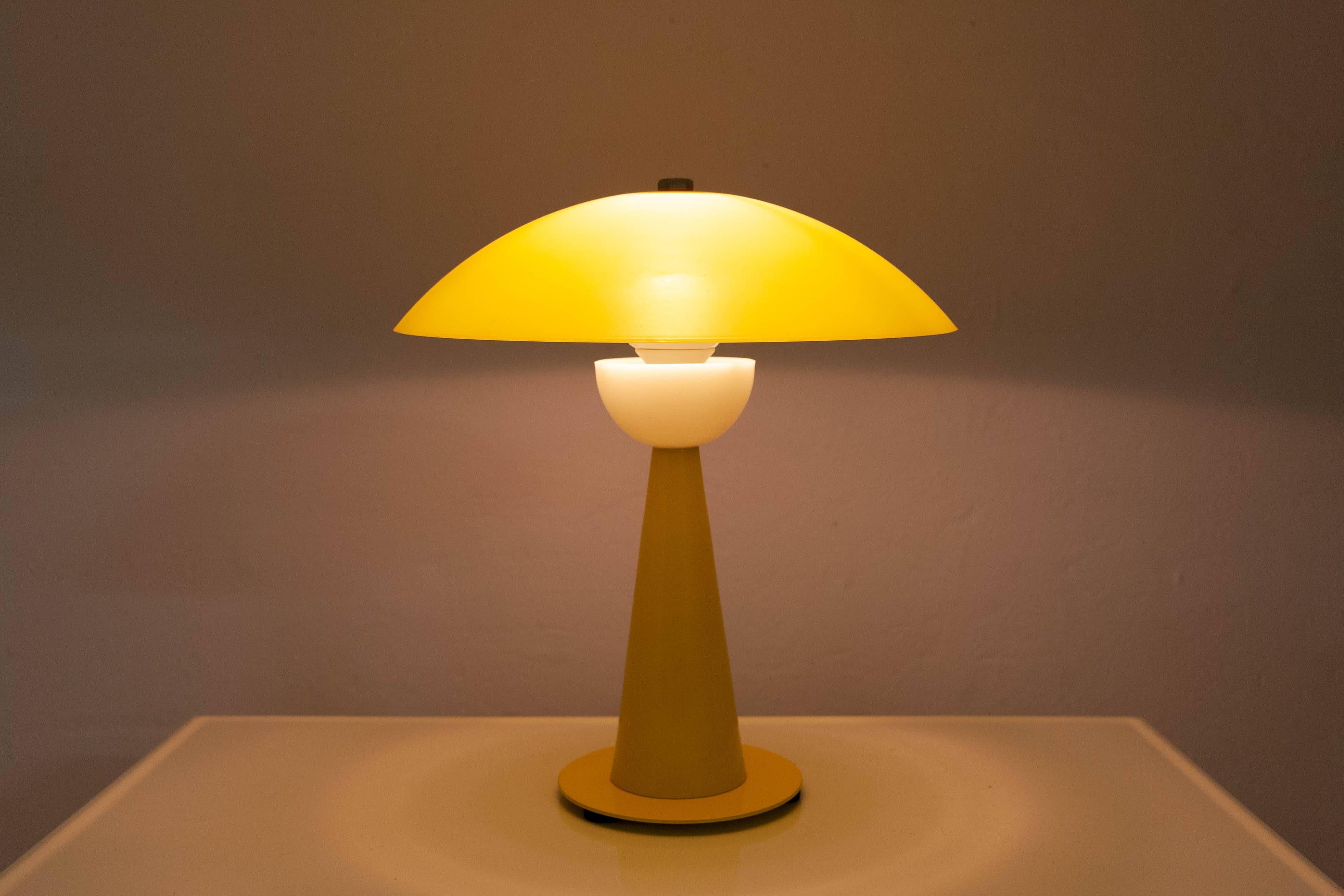 Charming little table lamp by Aluminor France in an eye-catching bright yellow finish.
