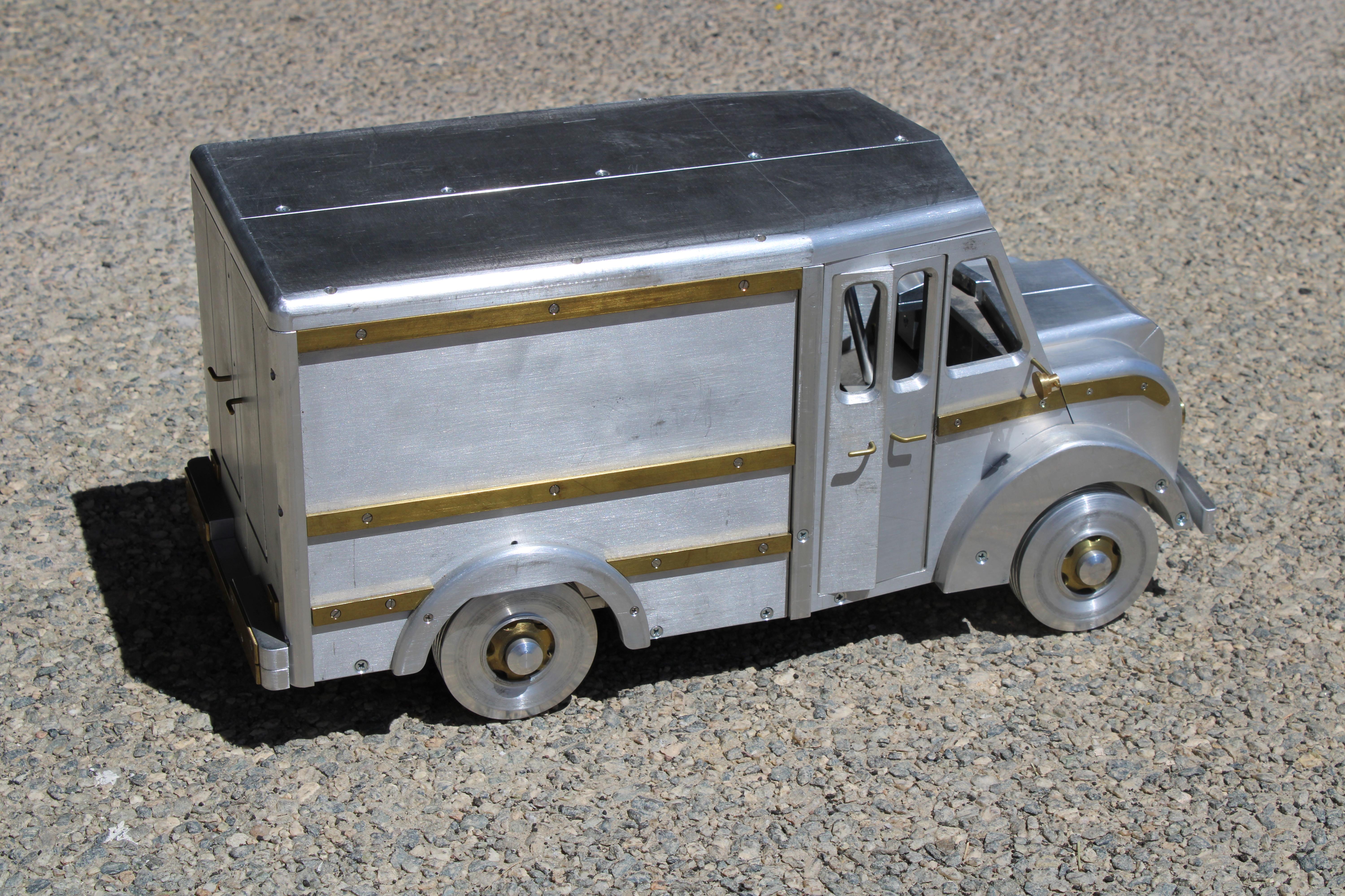 Studio aluminum and brass Truck. Reminds me of a milk truck from the 60s or a salesman sample in a car dealership. We were told an engineer that worked at Alamogordo, NM made this truck and a jeep which is listed separately. The 4 wheels come off