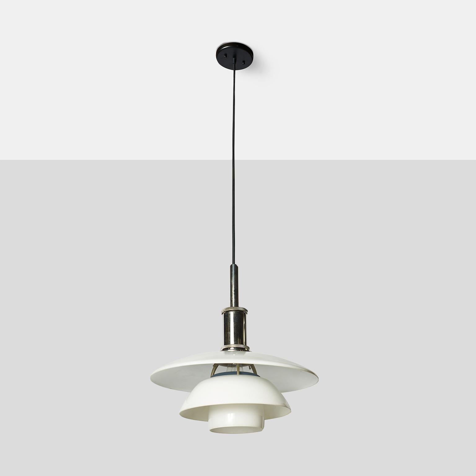 A PH 4½-4 pendant with a white-lacquered aluminum top shade and 2 white opal glass lower shades. Chromed metal socket cover.