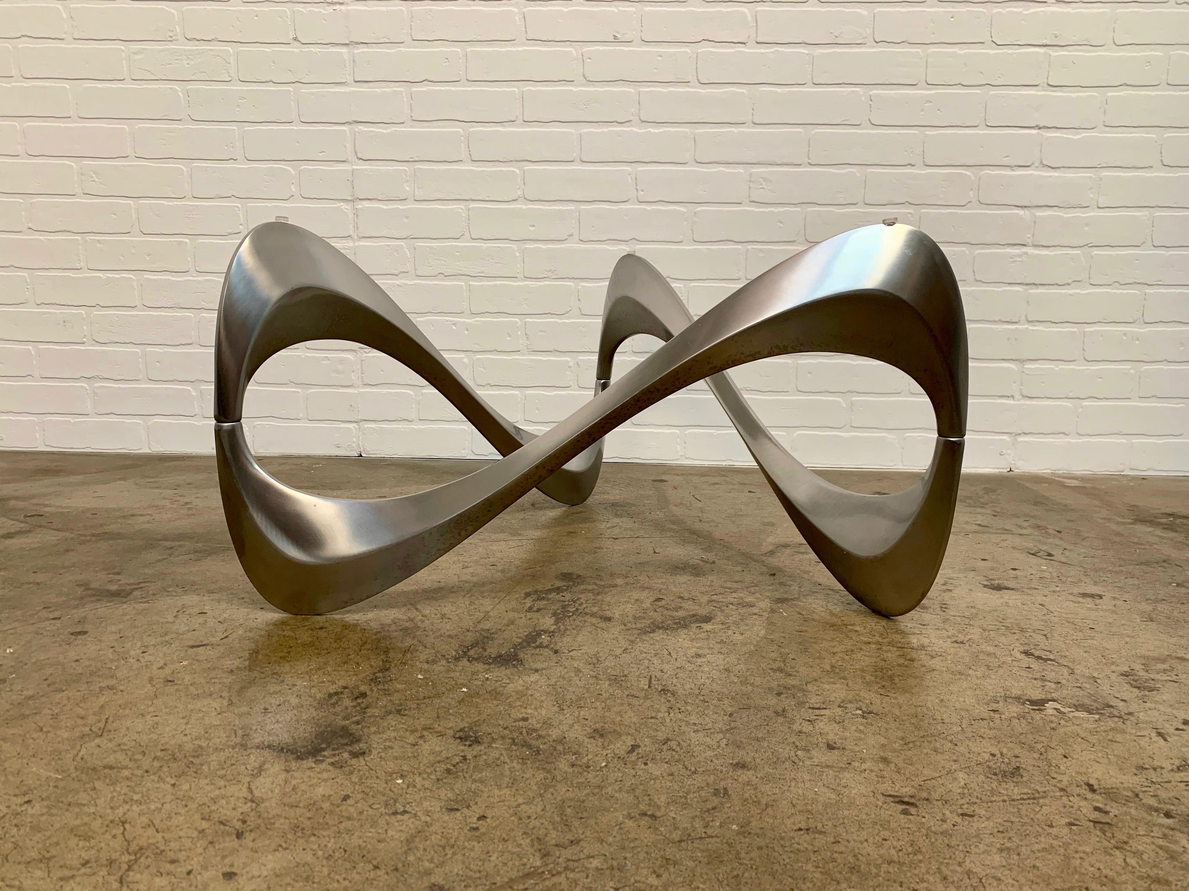 Sculptural coffee or cocktail table in form of a snake made of aluminum. The table was designed by Knut Hesterberg for German manufacturer Ronald Schmitt.
Glass measures: 51.5 by 33.75
Base is 26