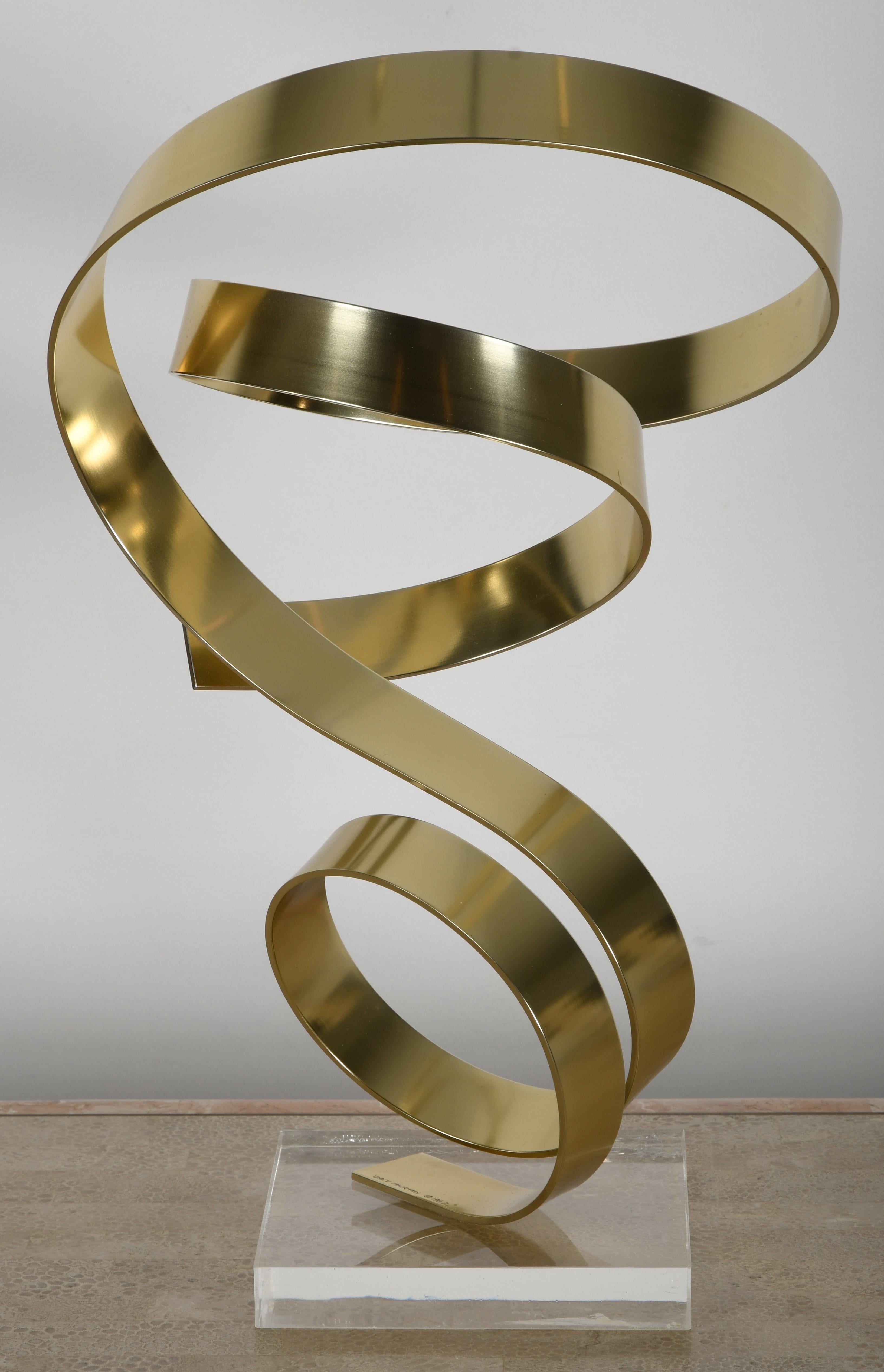 A stunning Dan Murphy abstract ribbon sculpture made of gold aluminum on an acrylic base. Signed and dated 1982. Some minor crazing to Lucite base, as shown in images. Very good condition with age appropriate wear.

Pedestal base not